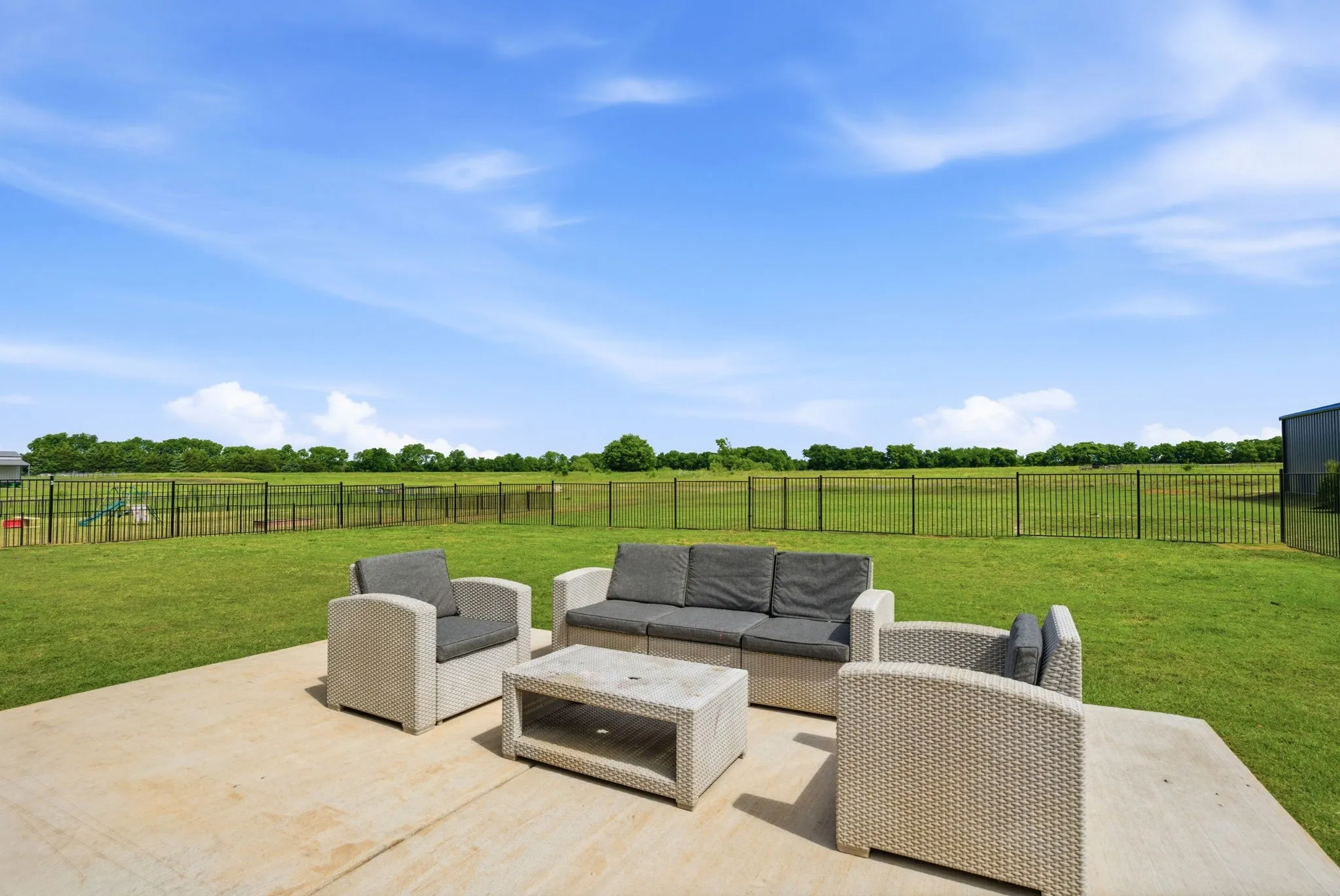 Iron (6 foot) fenced backyard secures kids & pets to play. Sprinkler system covers a portion of the backyard as well.