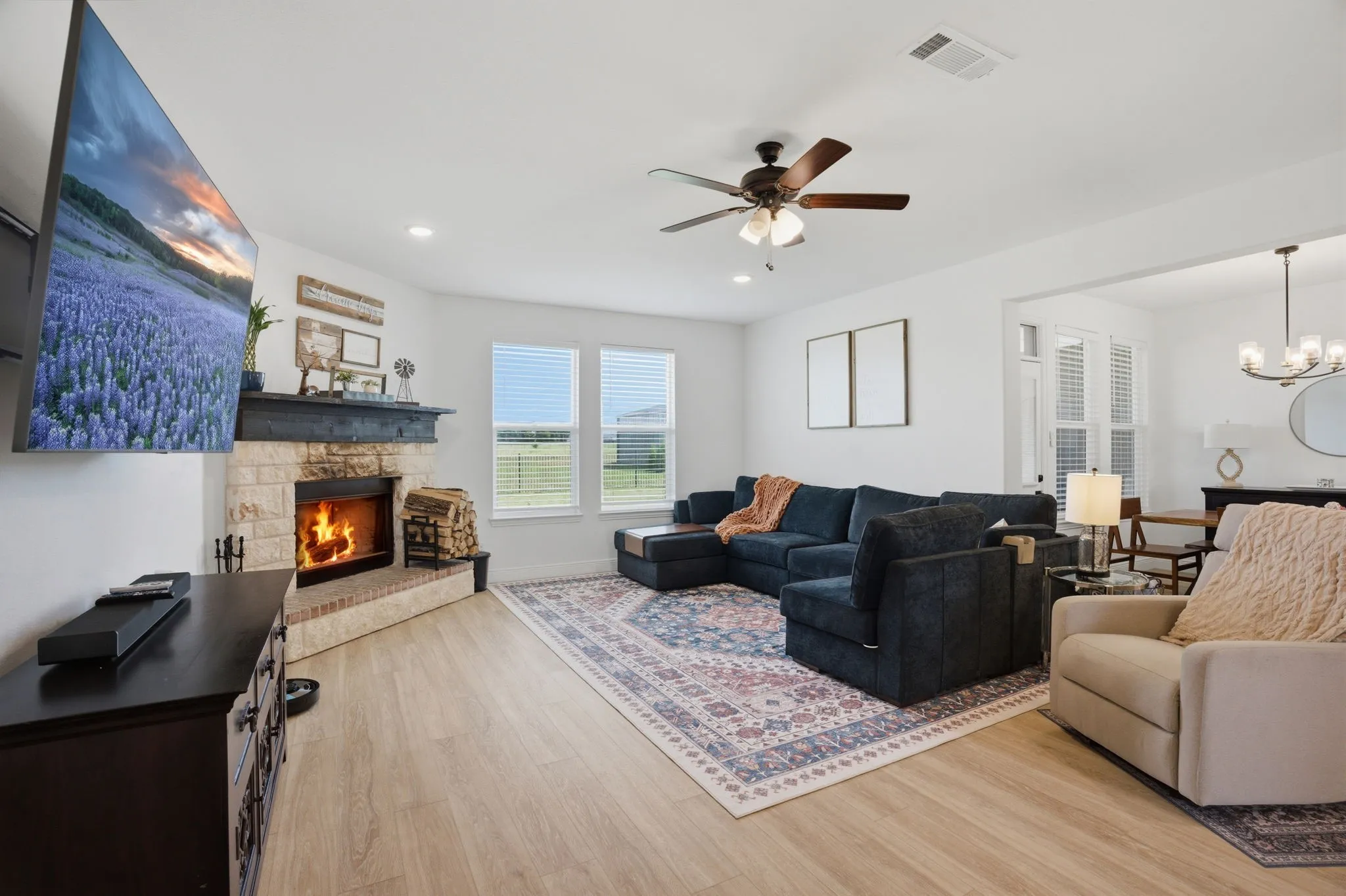 A favorite feature of the living room is the massive space it offers for many furniture pieces. Centered around the corner wood burning fireplace, you'll love the spaciousness yet cozy feel for everyday living.
