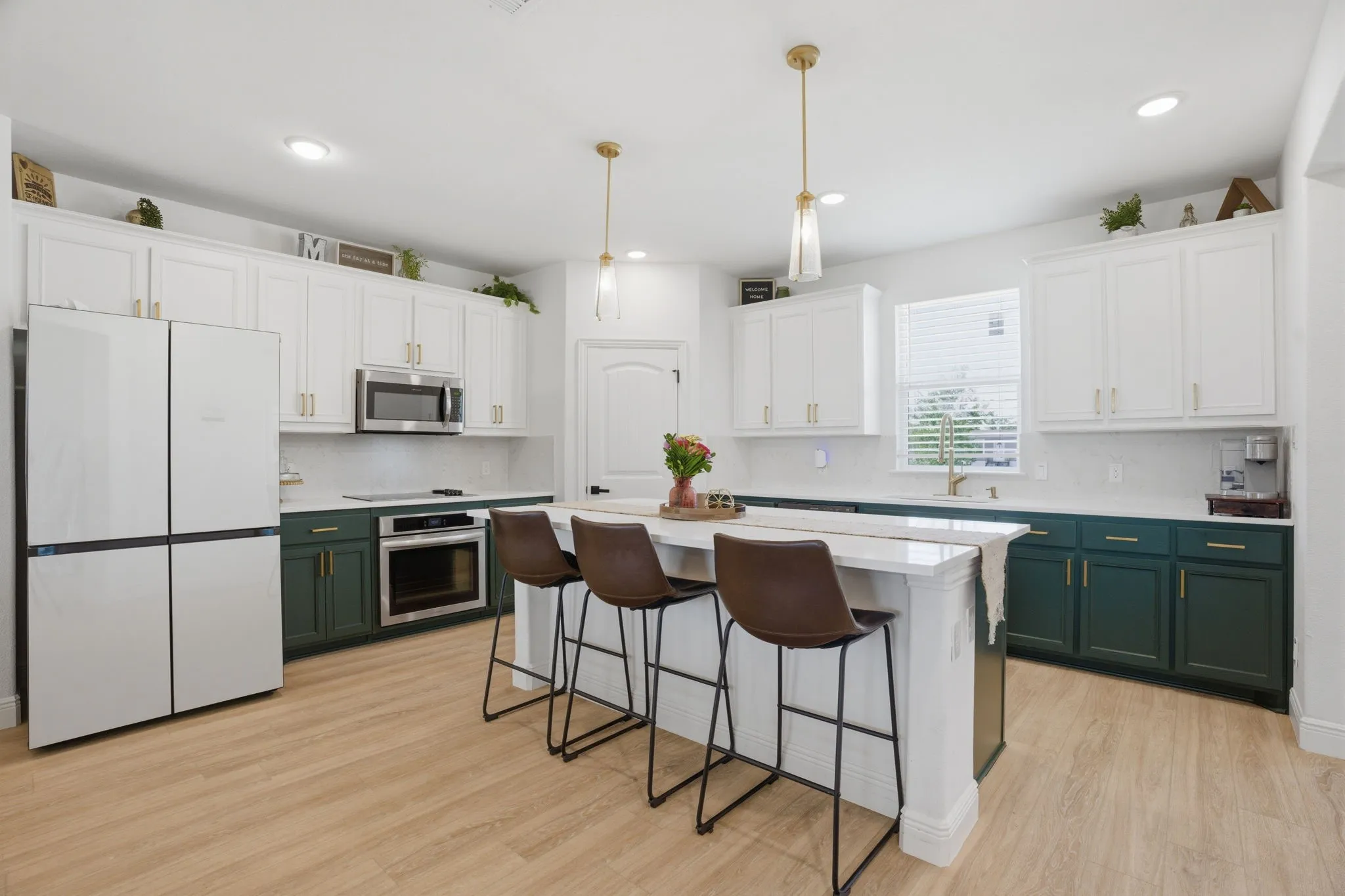 One of the prettiest kitchens you'll ever see! The sellers customized the look with painted cabinets + gold hardware & pendant lights. Just bring your own refrigerator.