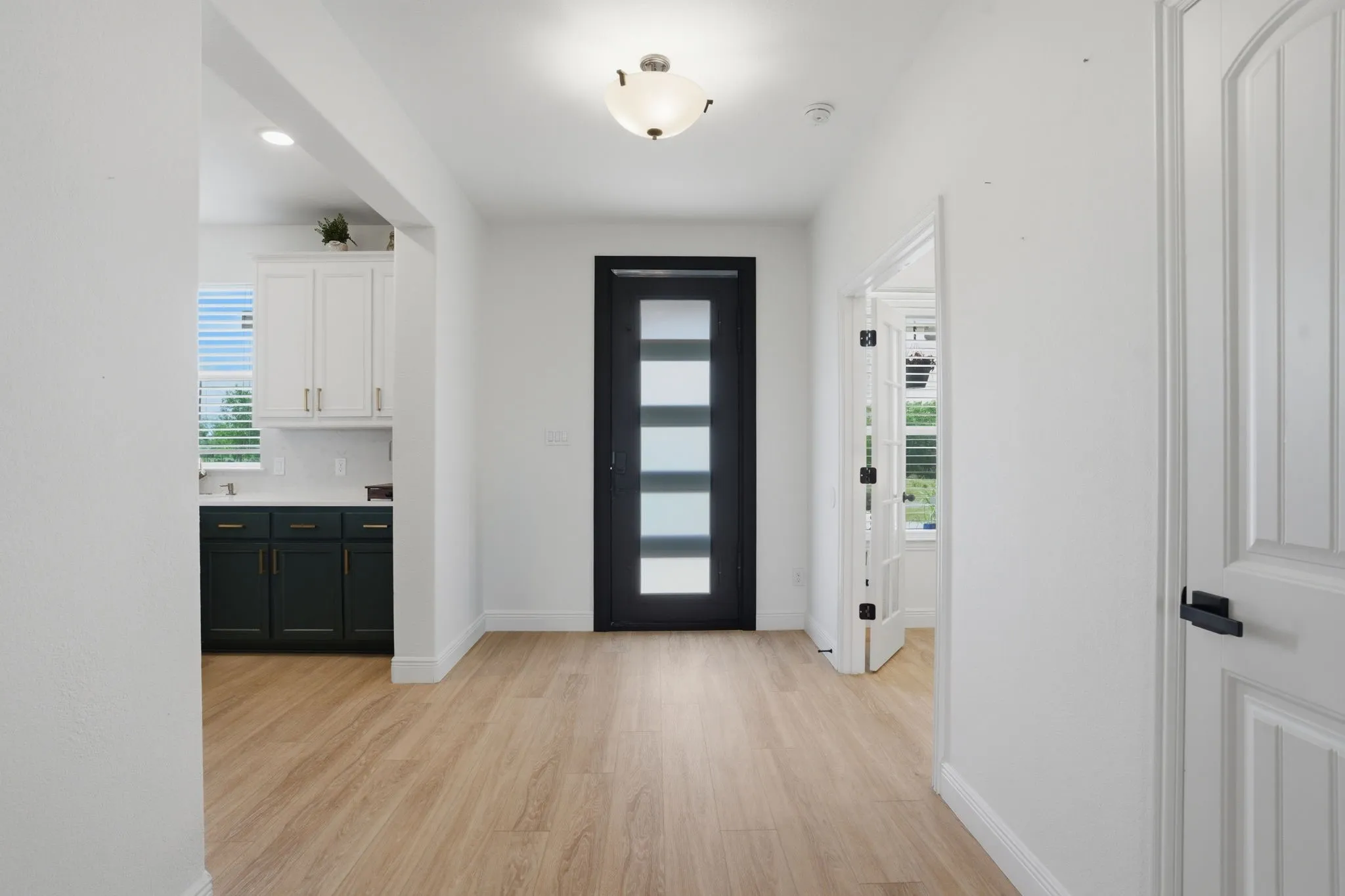 Love the 9-foot metal front door with flemish glass for additional light. 6 inch baseboards are among the many upgrades in this home.