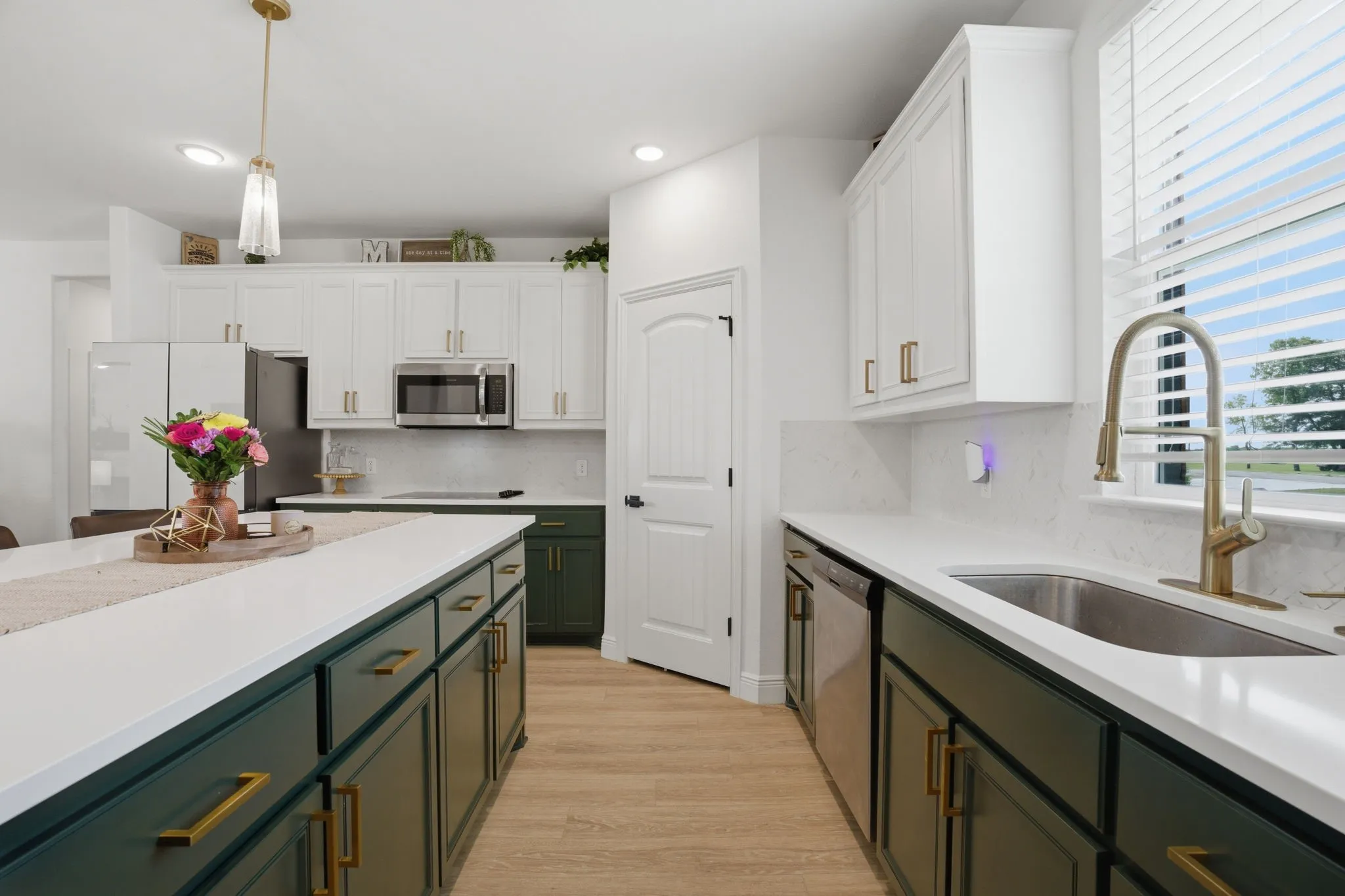 Everyone loves the clean look of quartz countertops & subway tile backsplash. Look at the amount of cabinet storage in addition to the corner walk-in pantry.