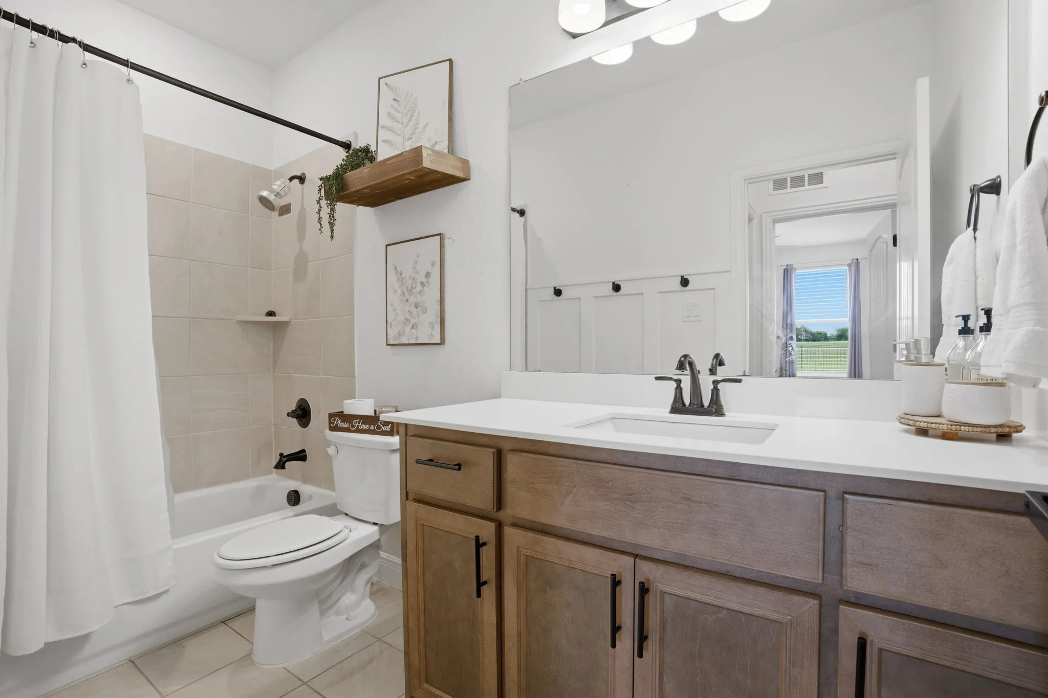 Full bath 2 is shared by the secondary bedrooms. Note the board & batten walls shown thru the mirror :)