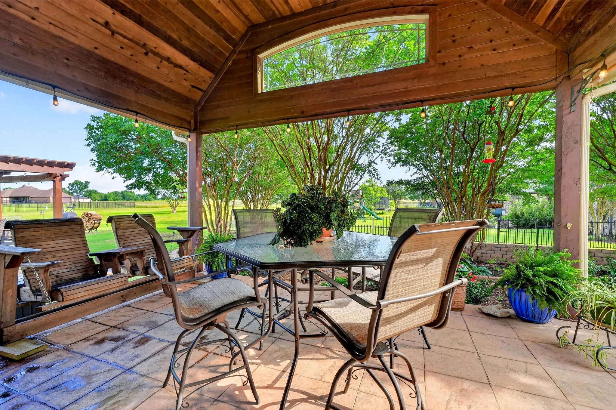 Covered patio featuring a wood-paneled ceiling and a stamped concrete floor