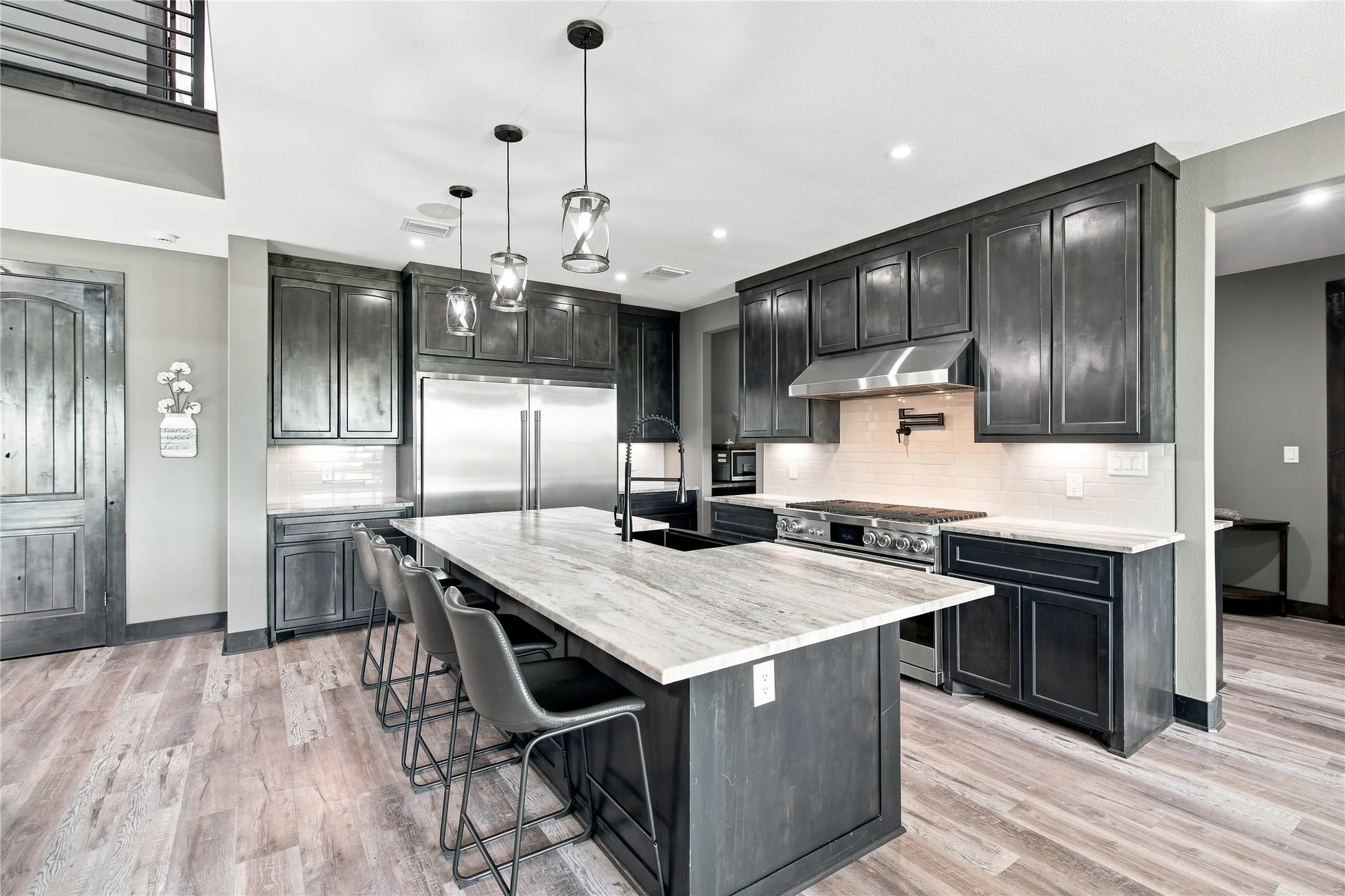 KITCHEN WITH LARGE ISLAND AND BUILT IN REFRIDGERATOR AND FREEZER