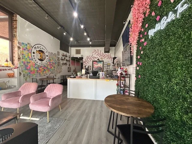 115 E Wall Street is leased by Boba Tea Cafe and the unit is available for sale for $169,000.  All four units may be purchased together or individually. Commercial interior featuring light-toned wood-finish flooring and a dark ceiling with track lighting