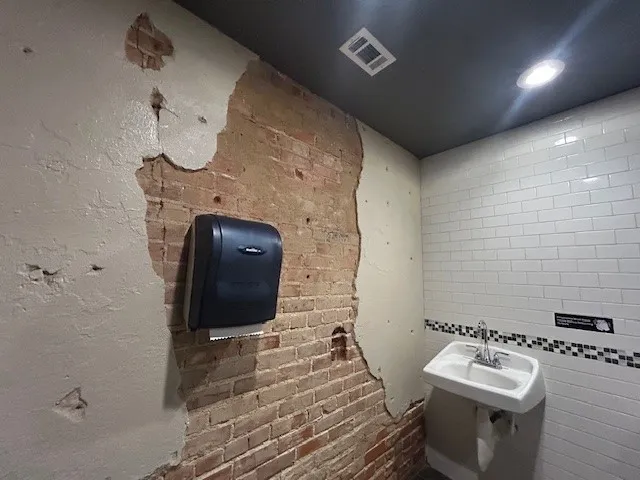 115 E Wall Street with Exposed brick wall with partial plaster finish