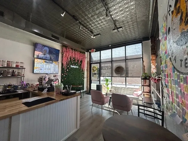 115 E Wall Street with Commercial interior featuring a white beadboard service counter with a wood-finish countertop, track lighting, and a pressed tin ceiling