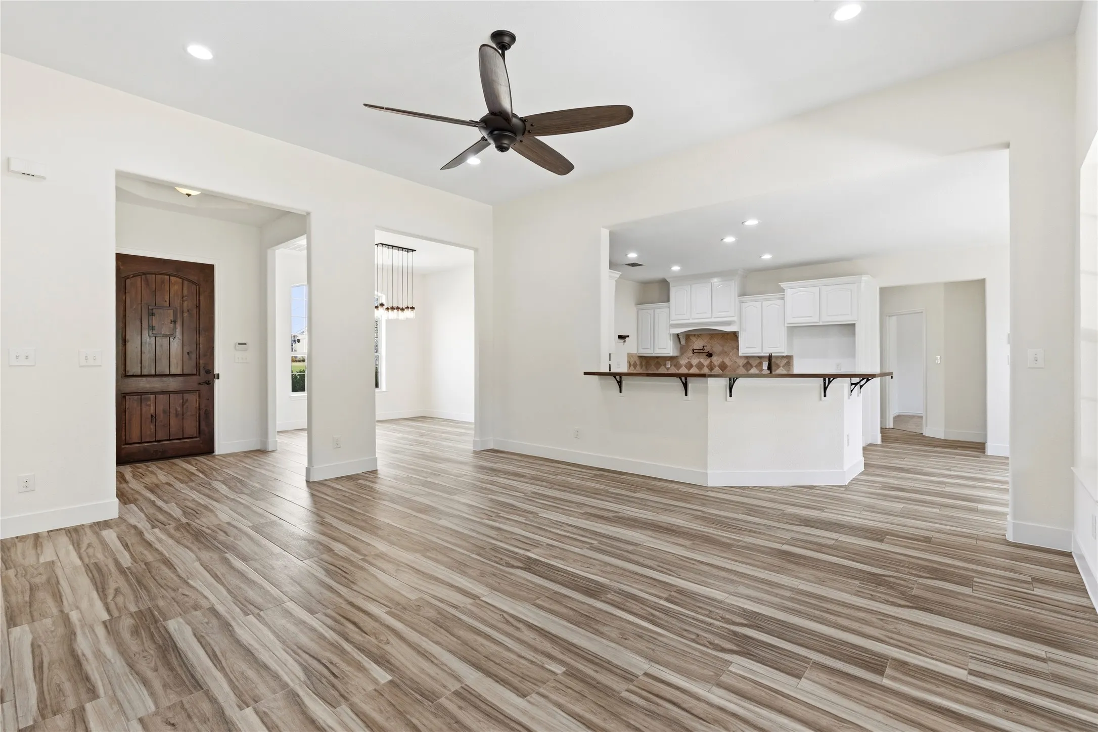 Easily accessible from front entrance, dining, kitchen, and primary bedroom.