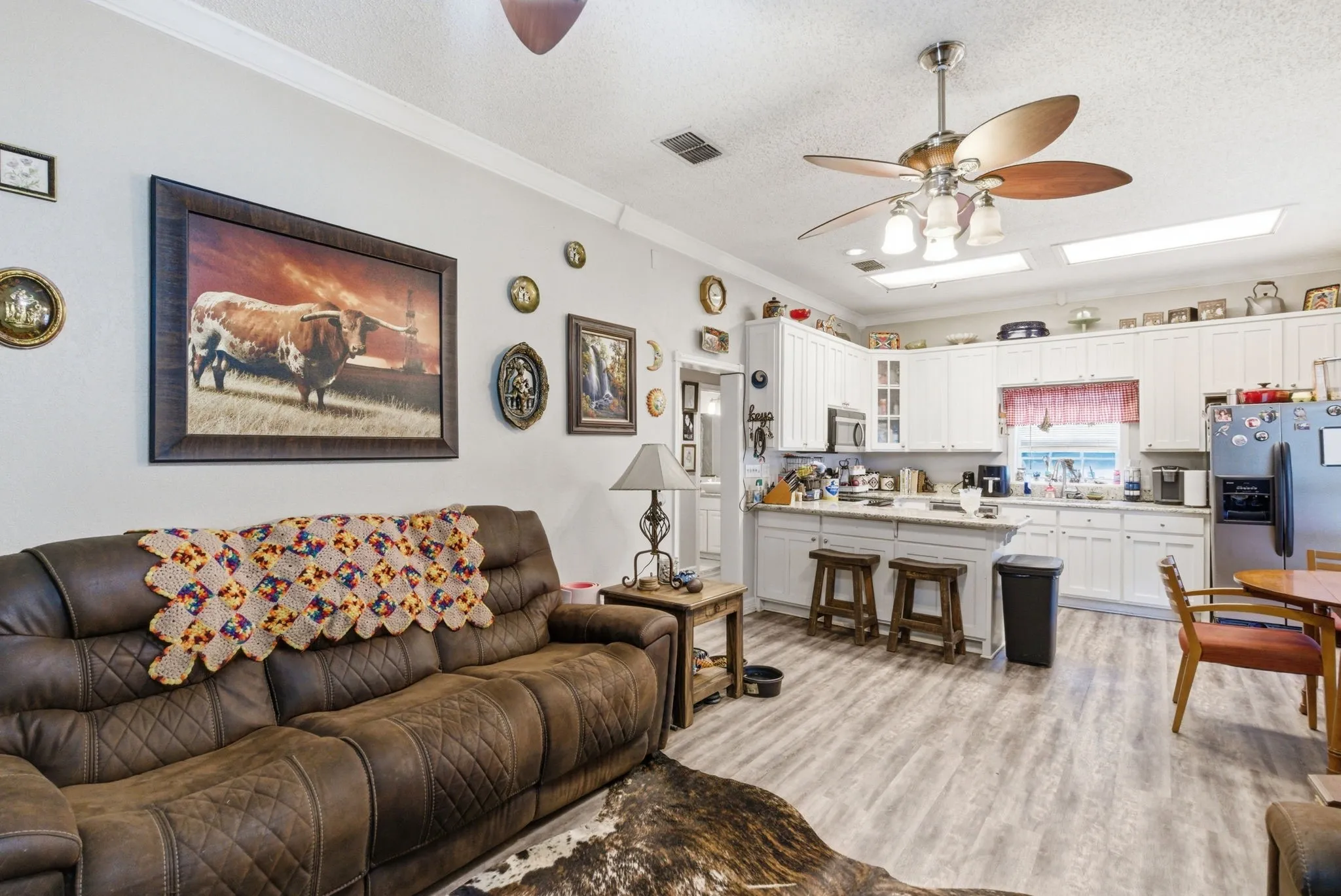 Open concept living area featuring wood-finish flooring