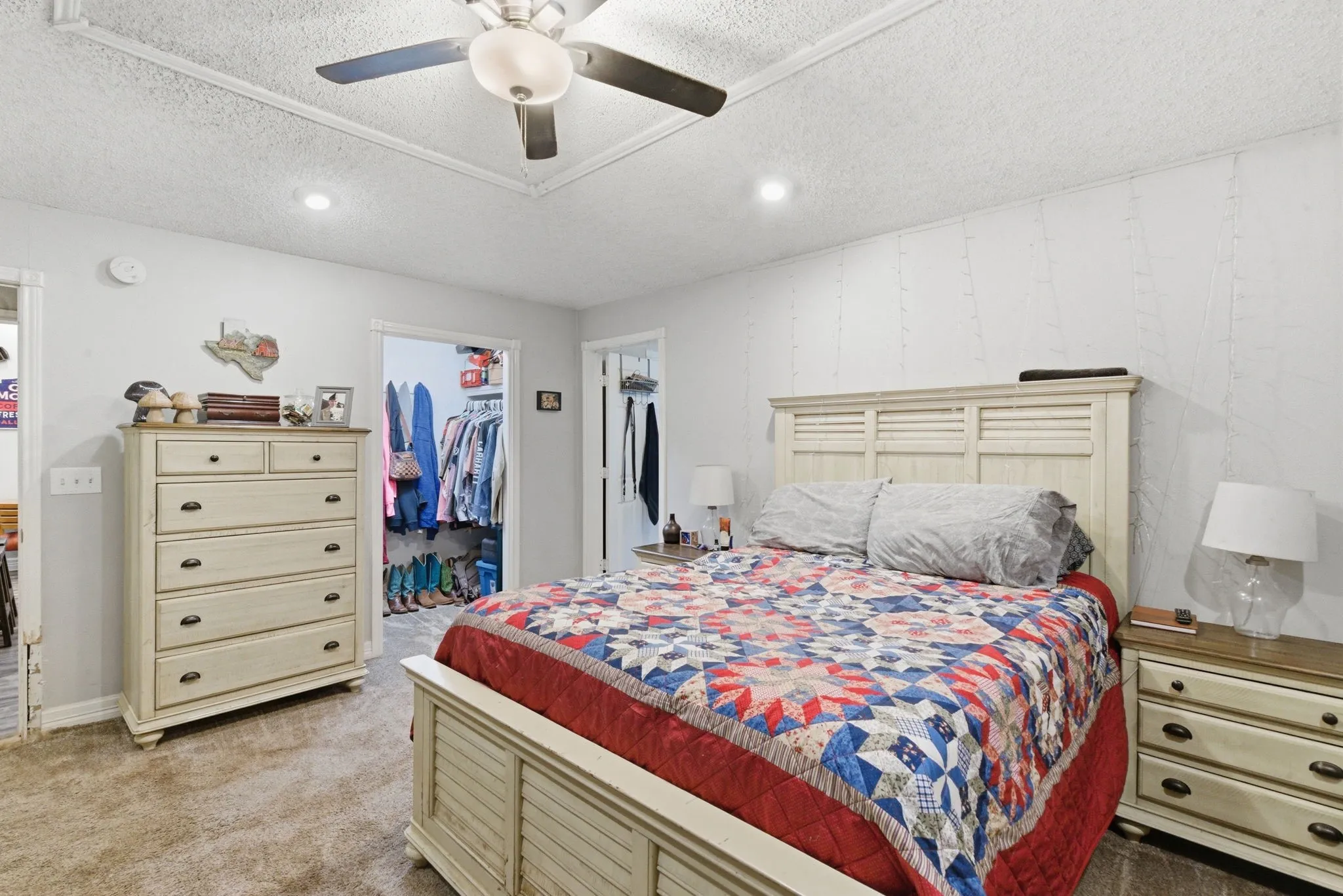 Carpeted bedroom featuring a ceiling fan, recessed lighting, and a walk-in closet with built-in shelving