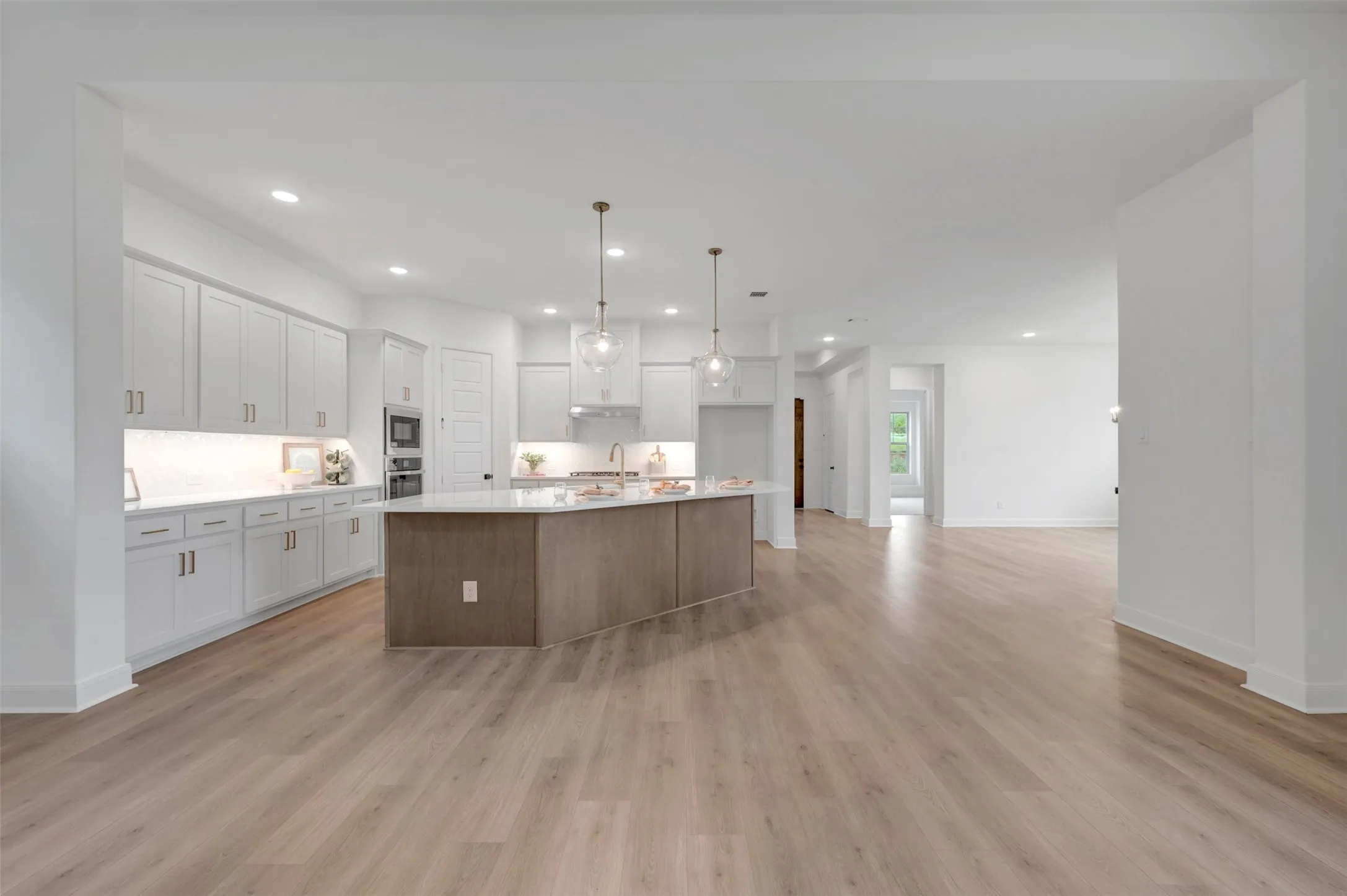 Open concept living area featuring wood-finish flooring