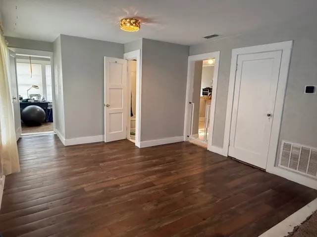 Wood-finish flooring throughout, complemented by light gray wall finishes and white trim