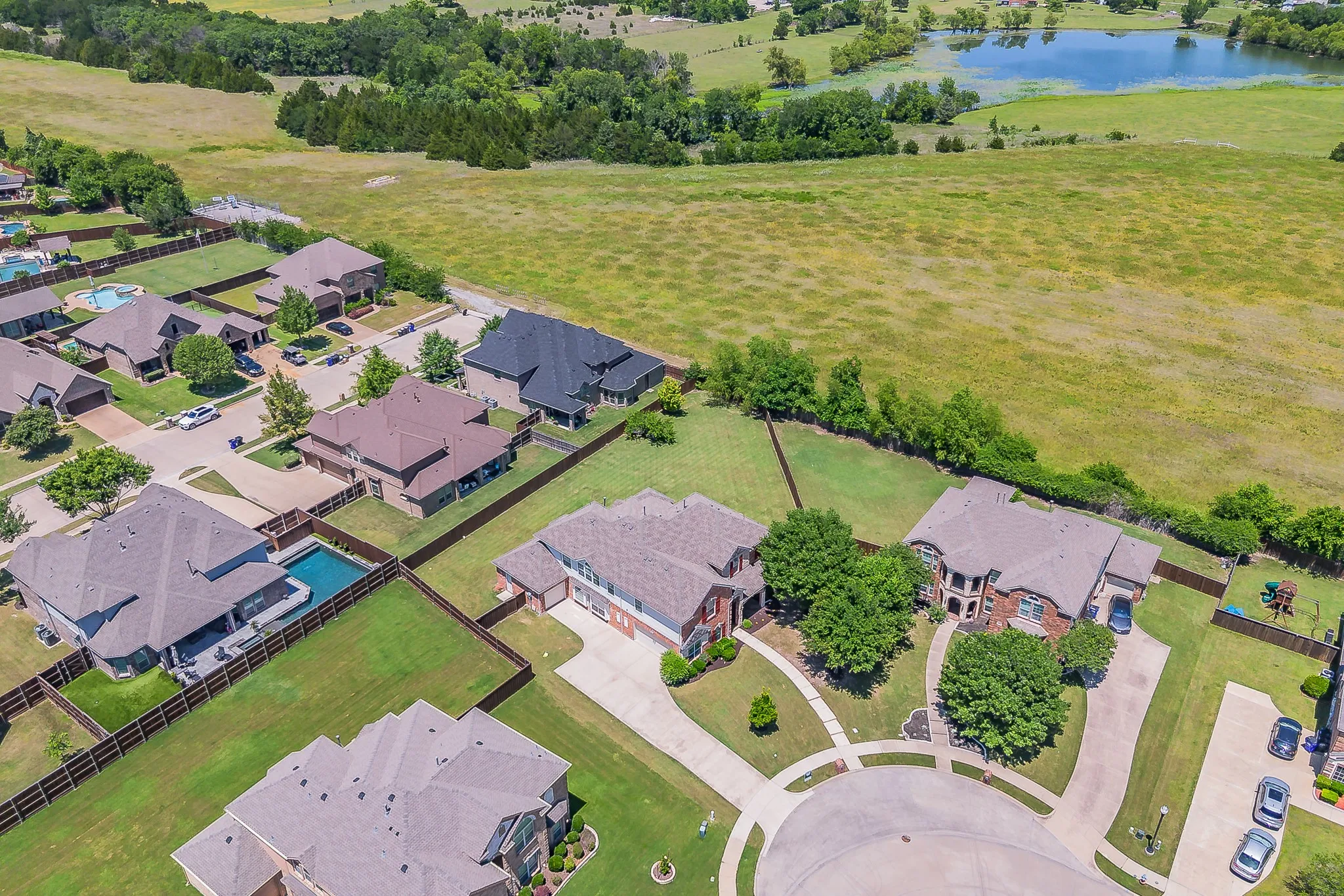 Aerial view of the large cul-de-sac lot and the green space behind the home.