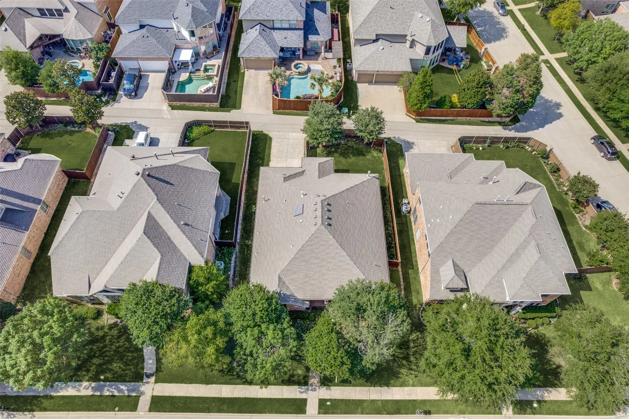 Aerial view of this home from the front. Surrounded by much larger homes.