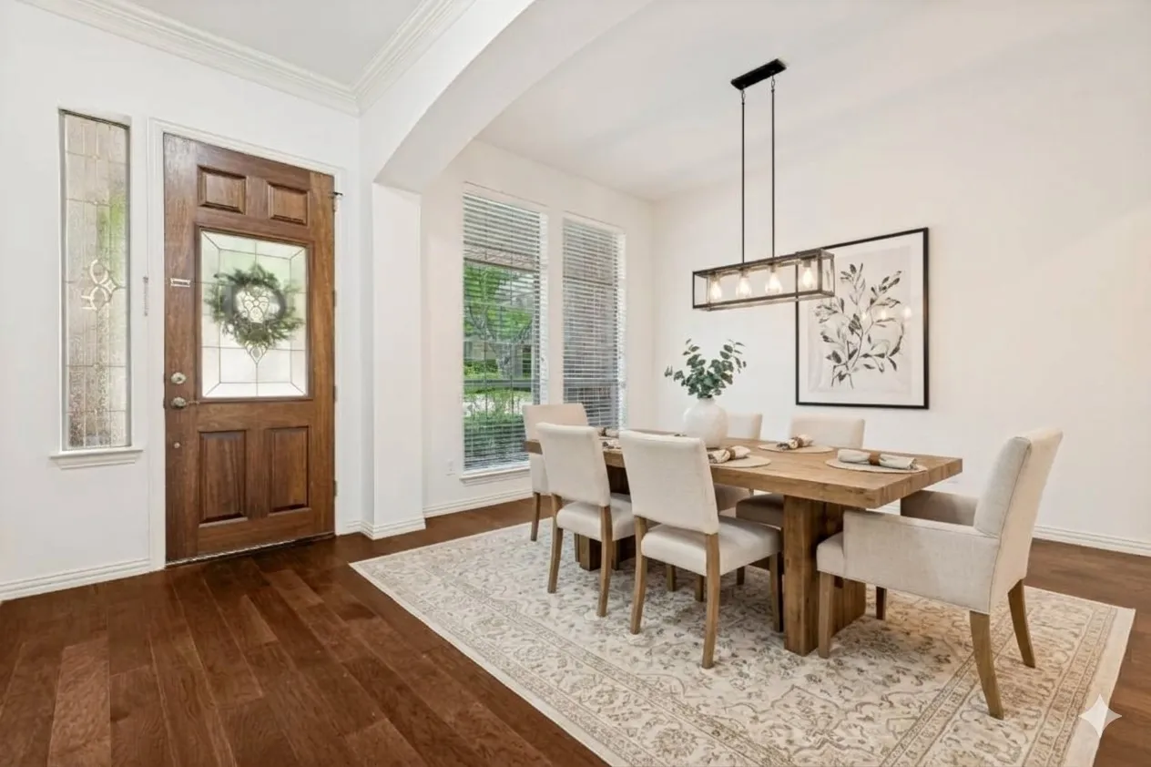 Light and bright dining room featuring rich engineered wood flooring, a decorative glass door, and updated modern lighting with a dimmer switch. *Virtually staged