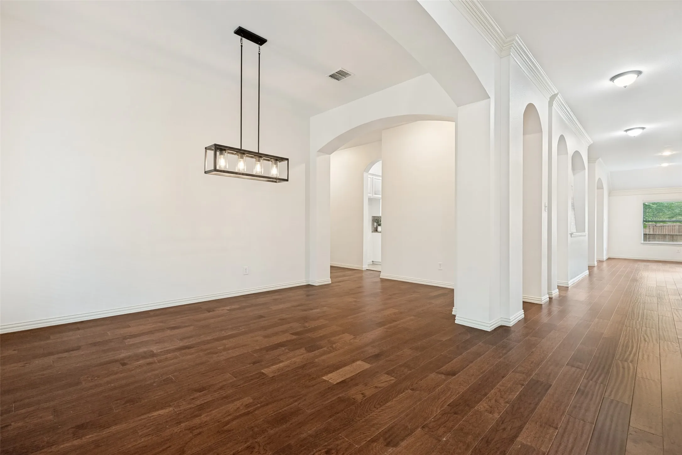 Beautiful light and bright Dining Room with updated lighting, fresh paint and easy access to the kitchen.