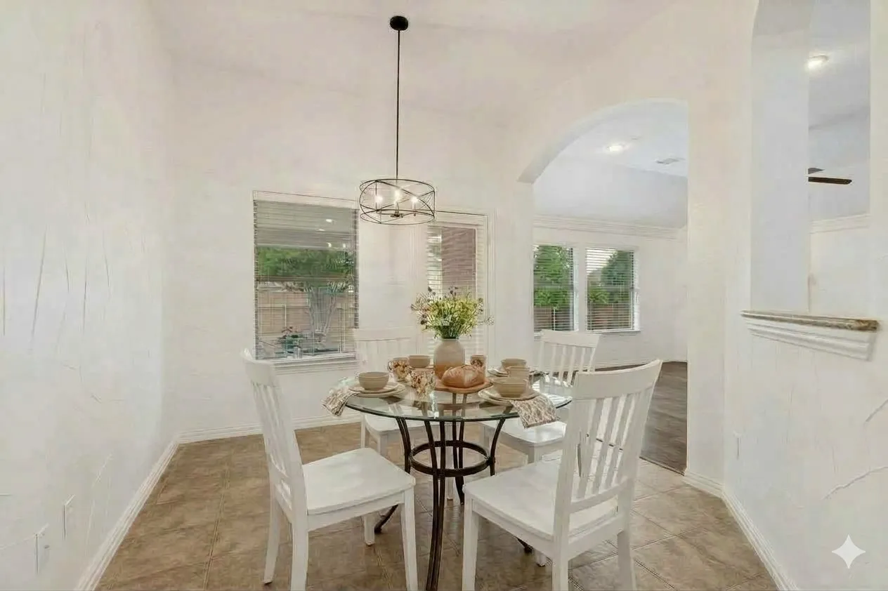 Light and bright breakfast room with modern lighting and views of the backyard and covered patio.*Virtually staged