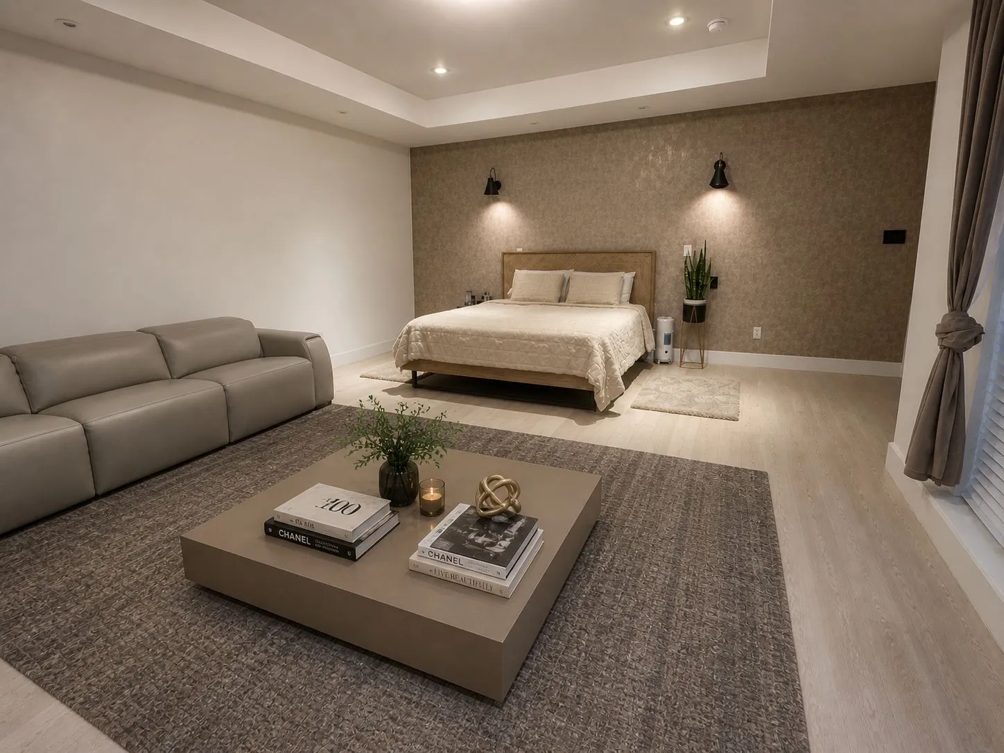Recessed lighting illuminates a spacious room featuring wood-finish flooring and a textured accent wall