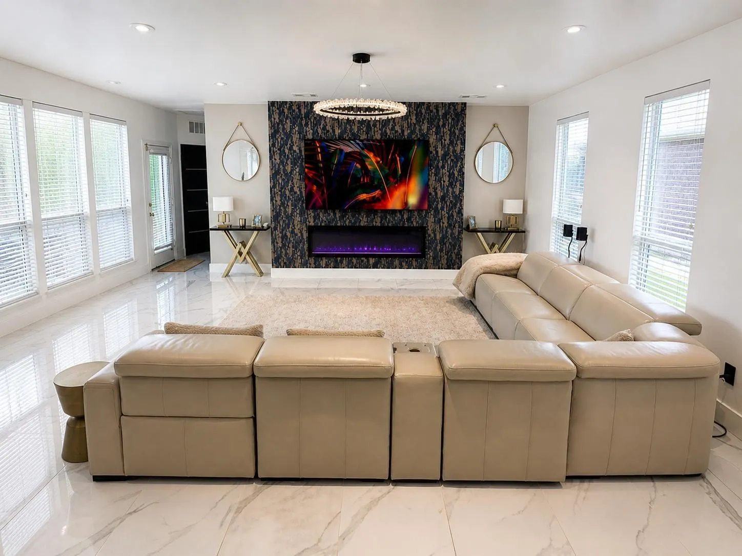 Spacious living area featuring polished white tile flooring, a dark accent wall with an integrated electric fireplace, and recessed lighting
