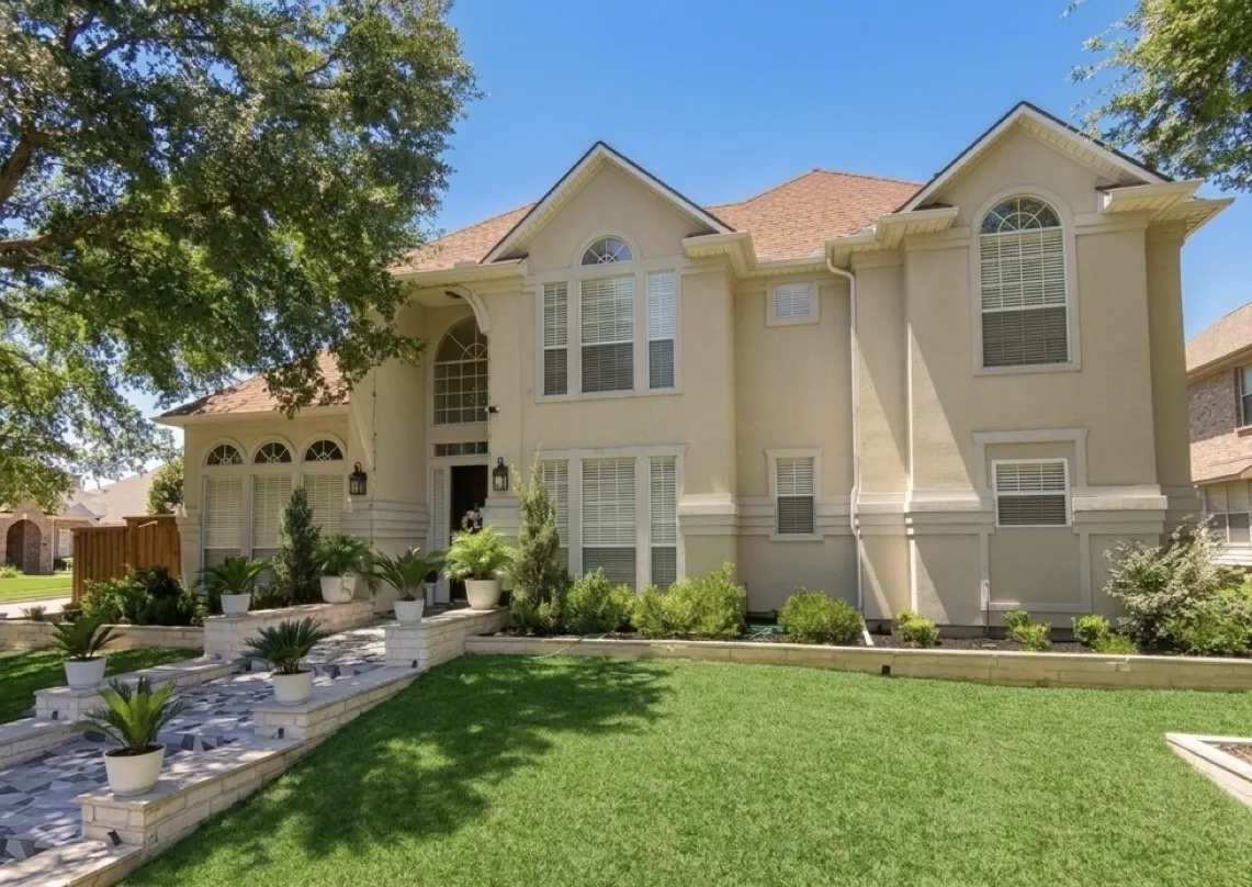 Stucco exterior residence with arched and rectangular windows