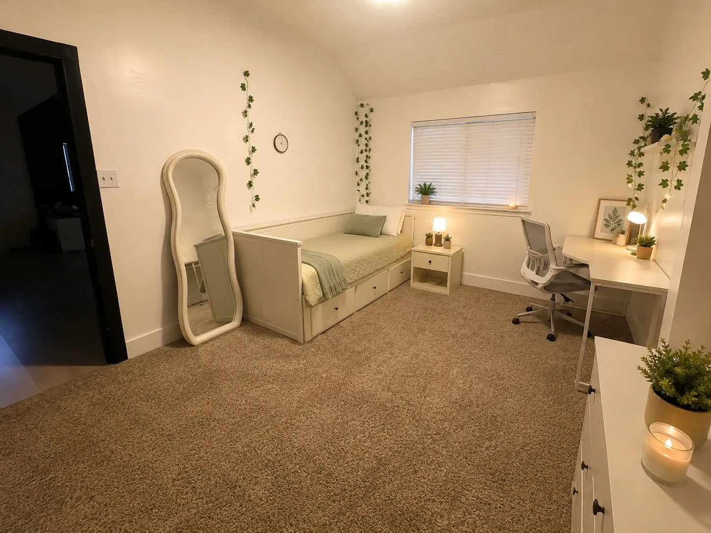 Carpeted interior room featuring white painted walls and a single window with blinds