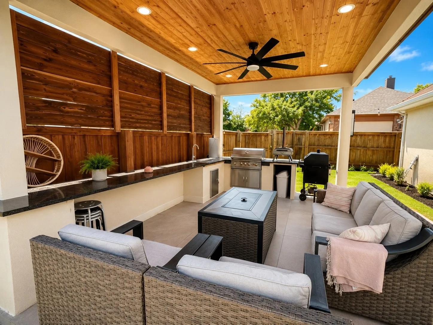 Covered patio featuring a wood-paneled ceiling with recessed lighting and a ceiling fan