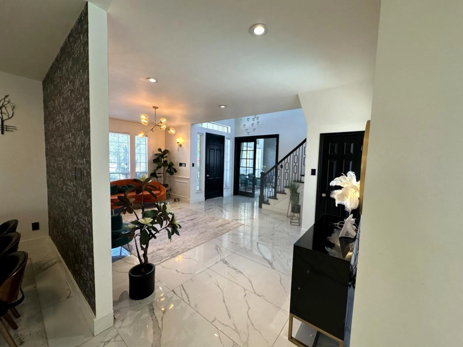 Spacious entryway featuring large format tile flooring, recessed lighting, and a modern chandelier