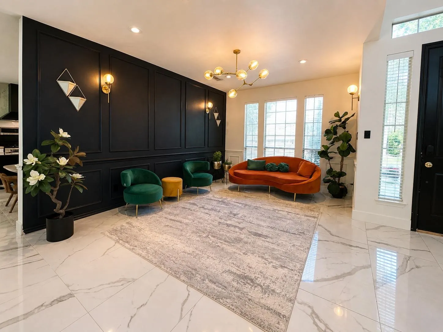 Spacious entryway featuring large format porcelain tile flooring, a paneled accent wall, multiple large windows, a contemporary chandelier, and wall sconces