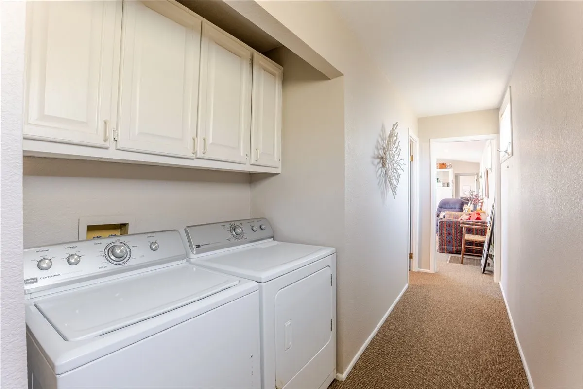 Nice laundry area with cabinets