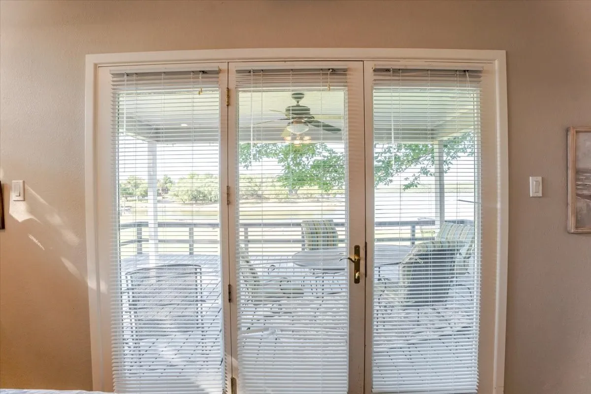 Nice entrance from the primary bedroom to the covered deck overlooking the lake