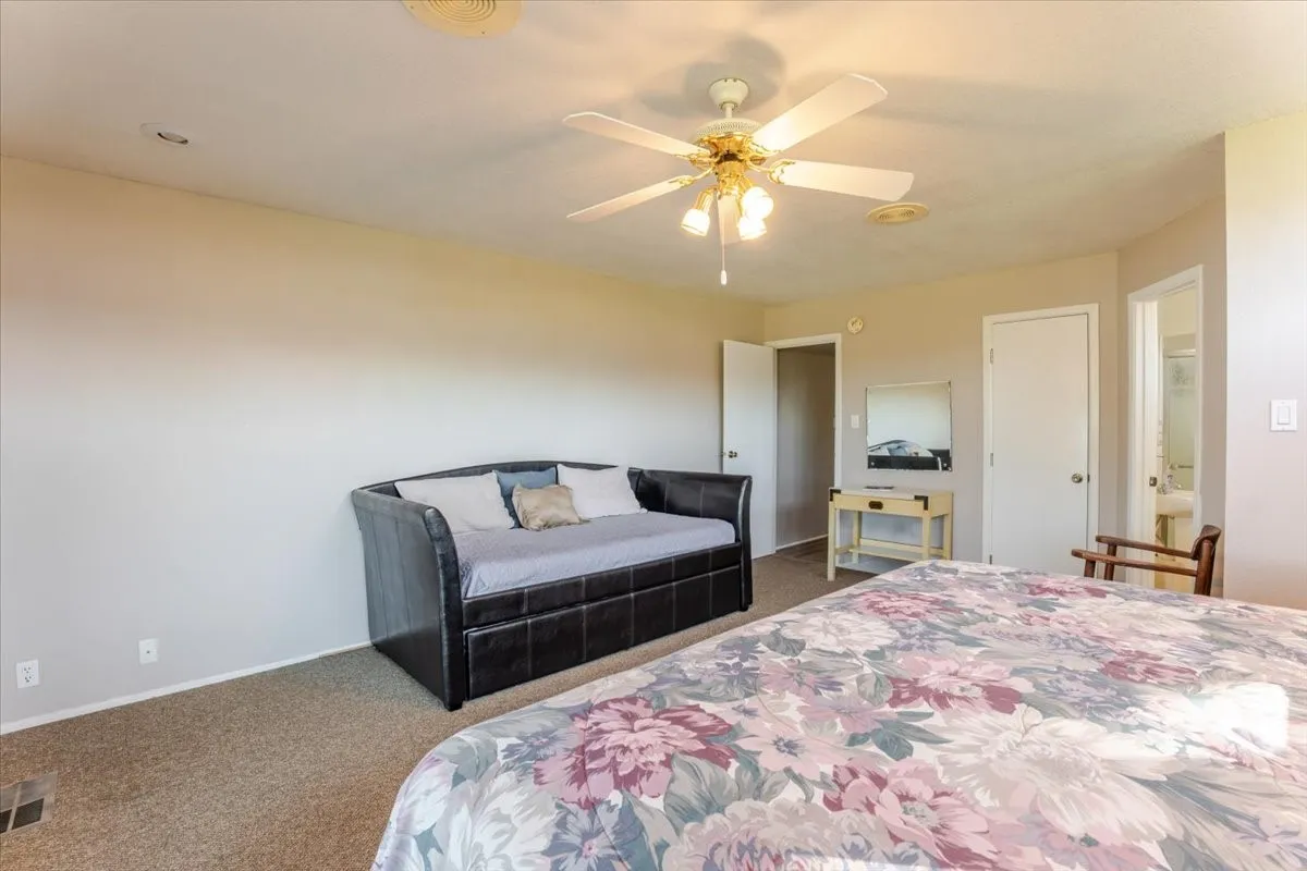 Spacious bedroom with a king and twin bed.