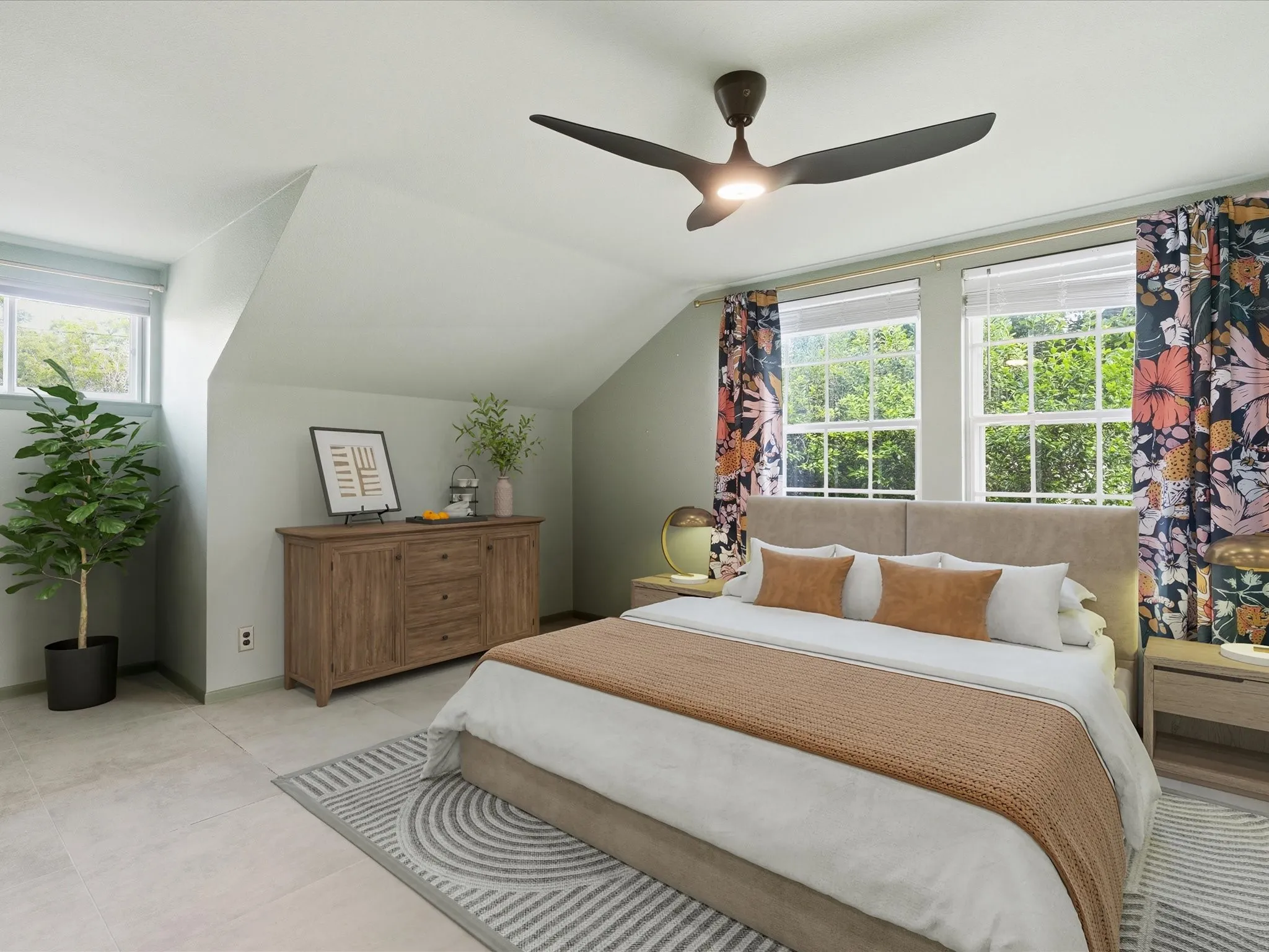 Room featuring sloped ceilings, multiple windows, and a ceiling fan with integrated lighting