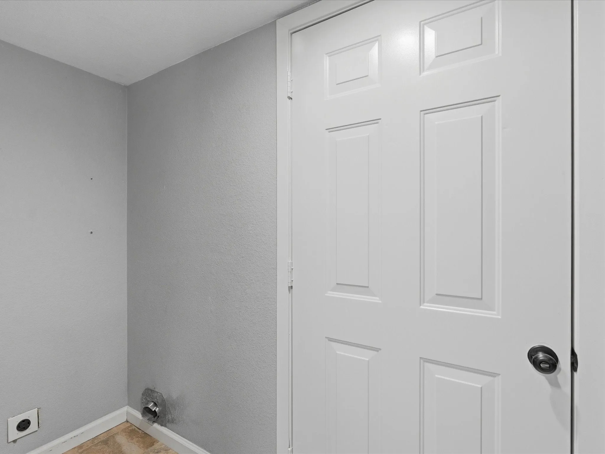 White paneled door with a dark circular doorknob