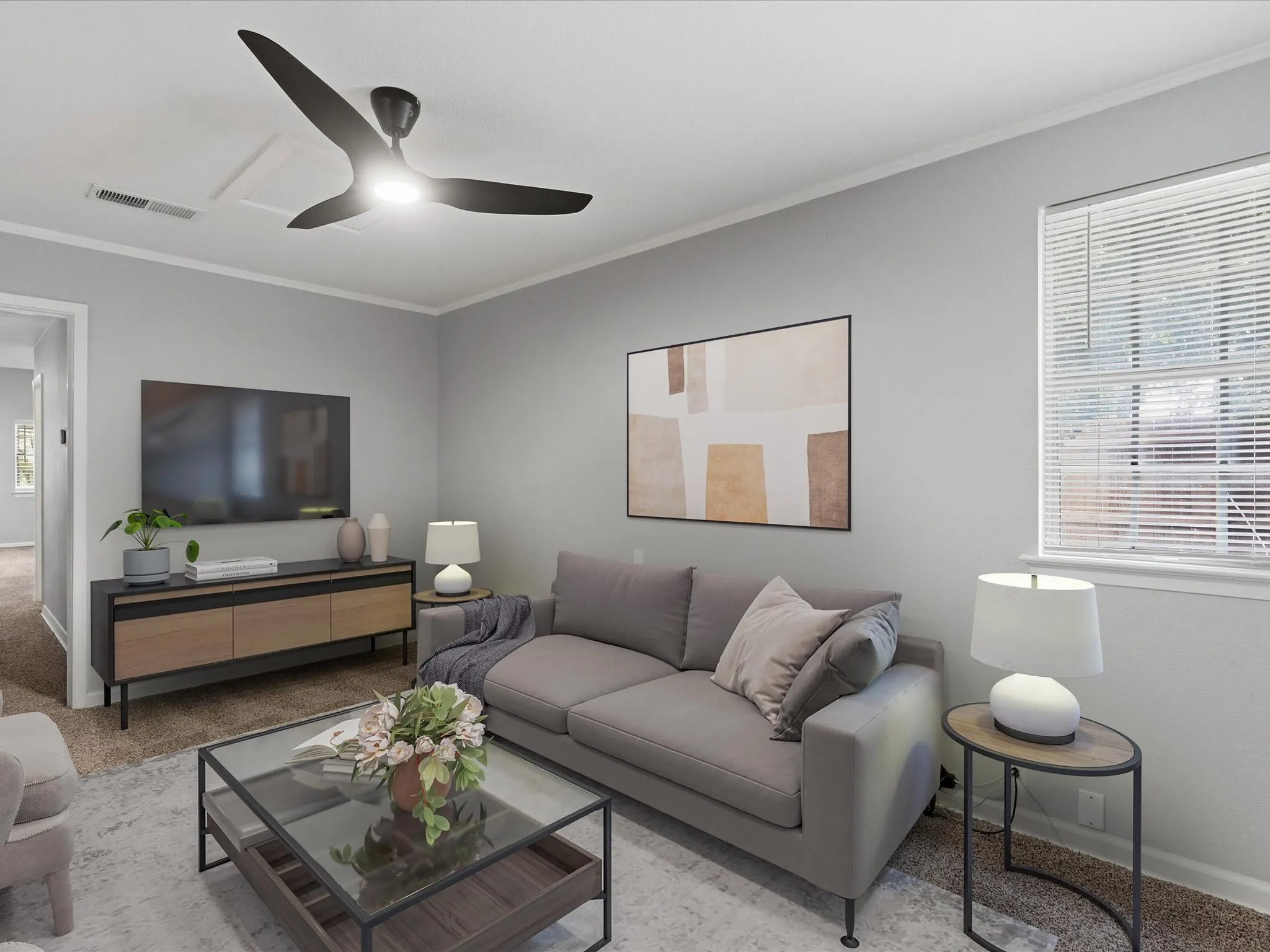 Living area featuring light gray walls, a modern ceiling fan with integrated lighting, and a large window with blinds