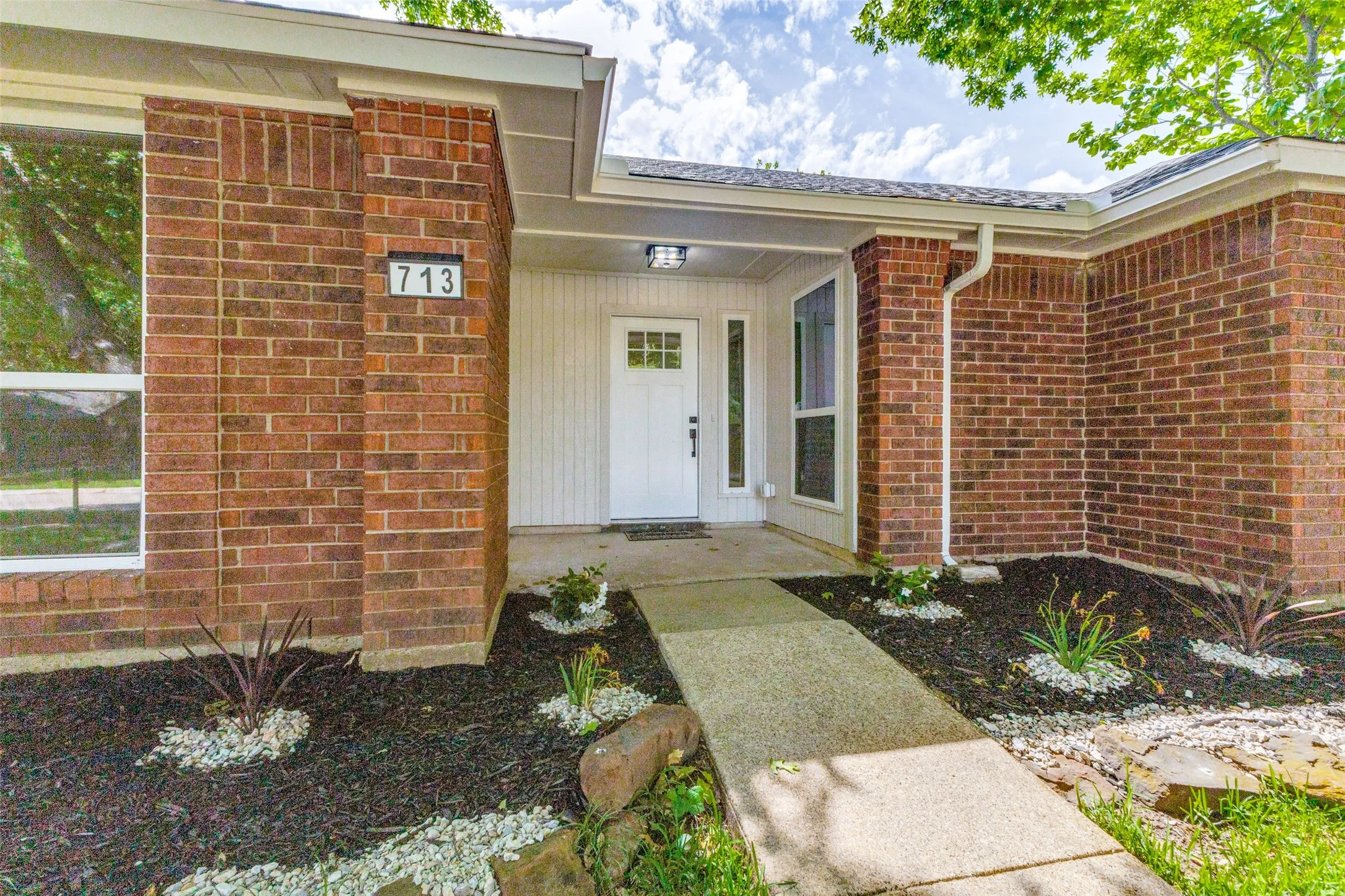 Brick exterior with white siding accents