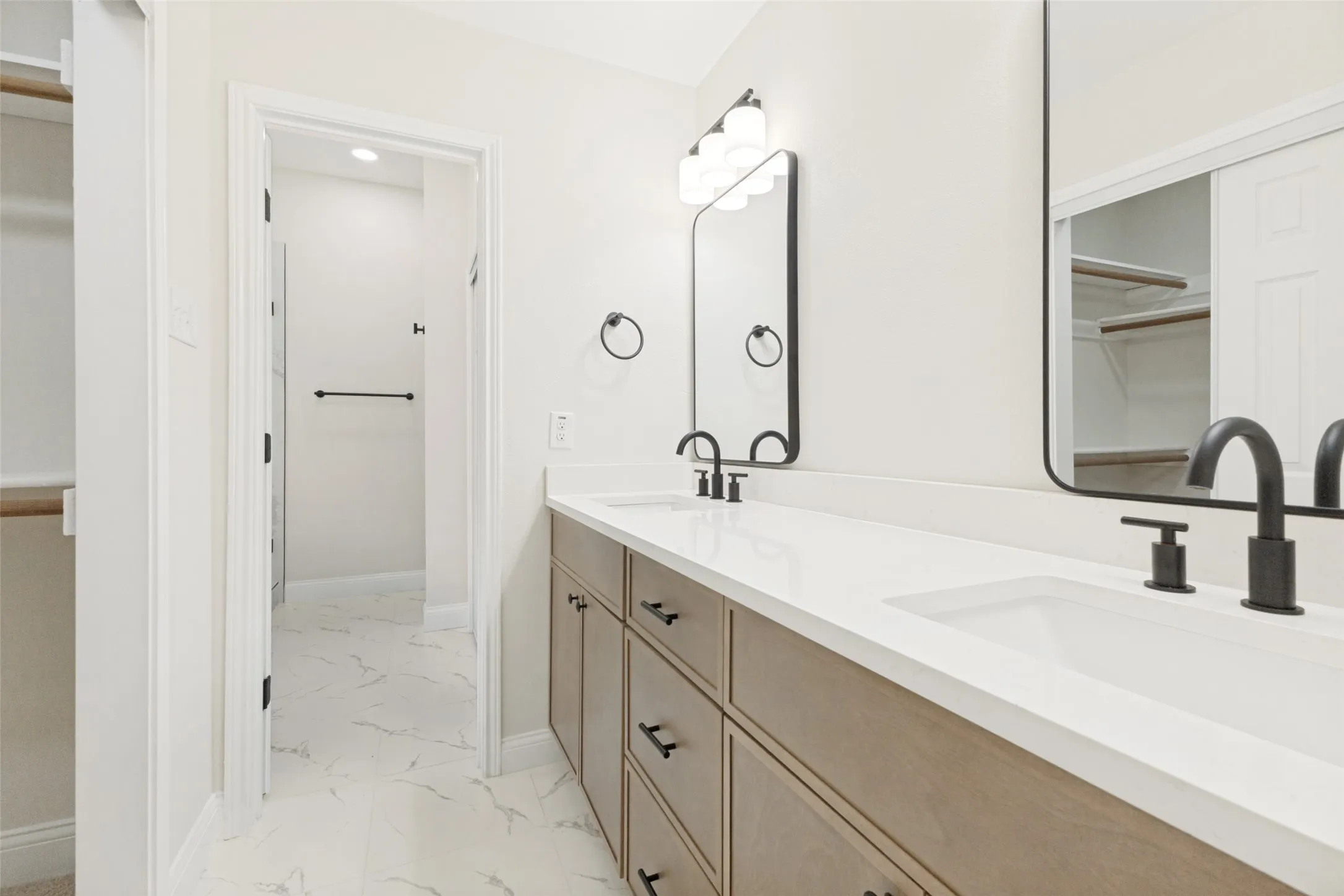 Double vanity with integrated sinks and white countertops