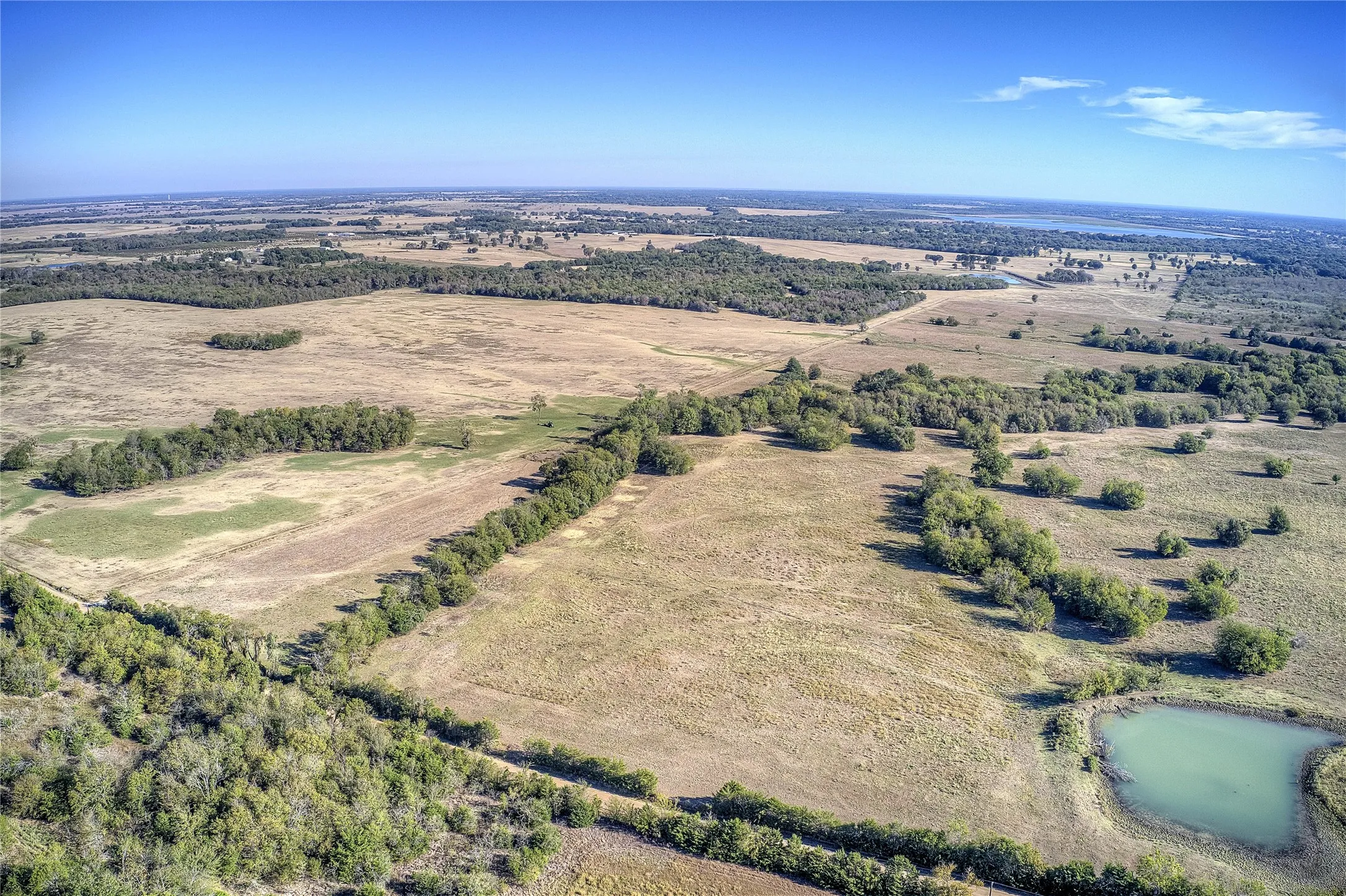 Birds eye view of property with a water view and a rural view