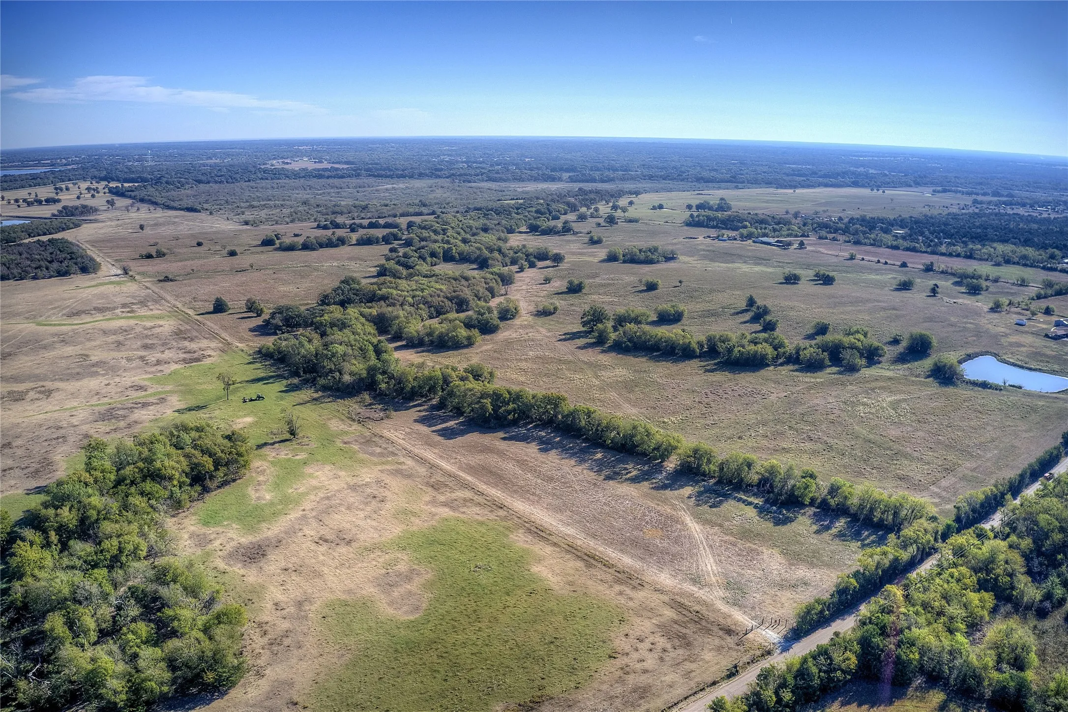 Aerial view featuring a rural view and a water view