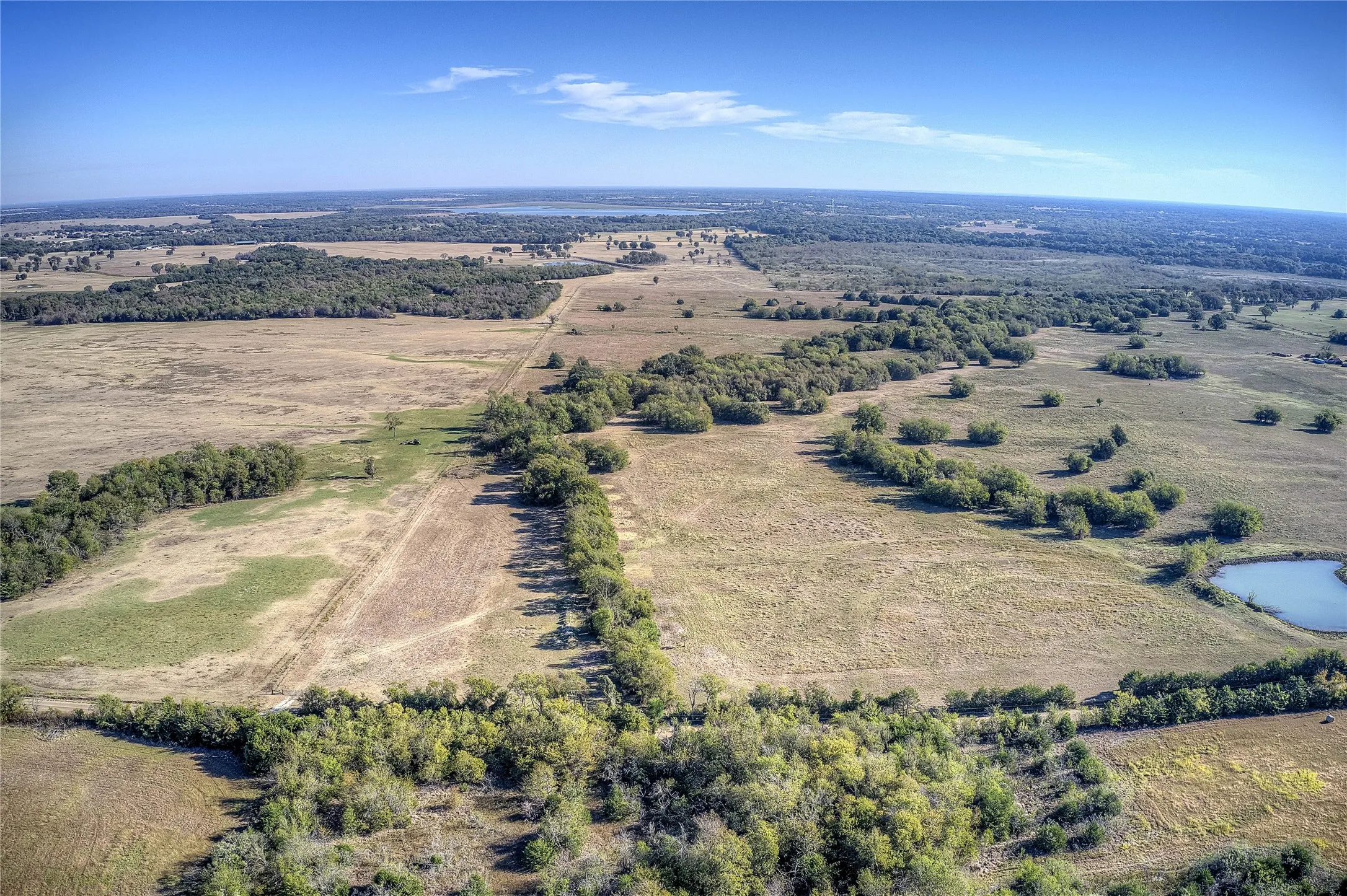 Birds eye view of property featuring a rural view and a water view