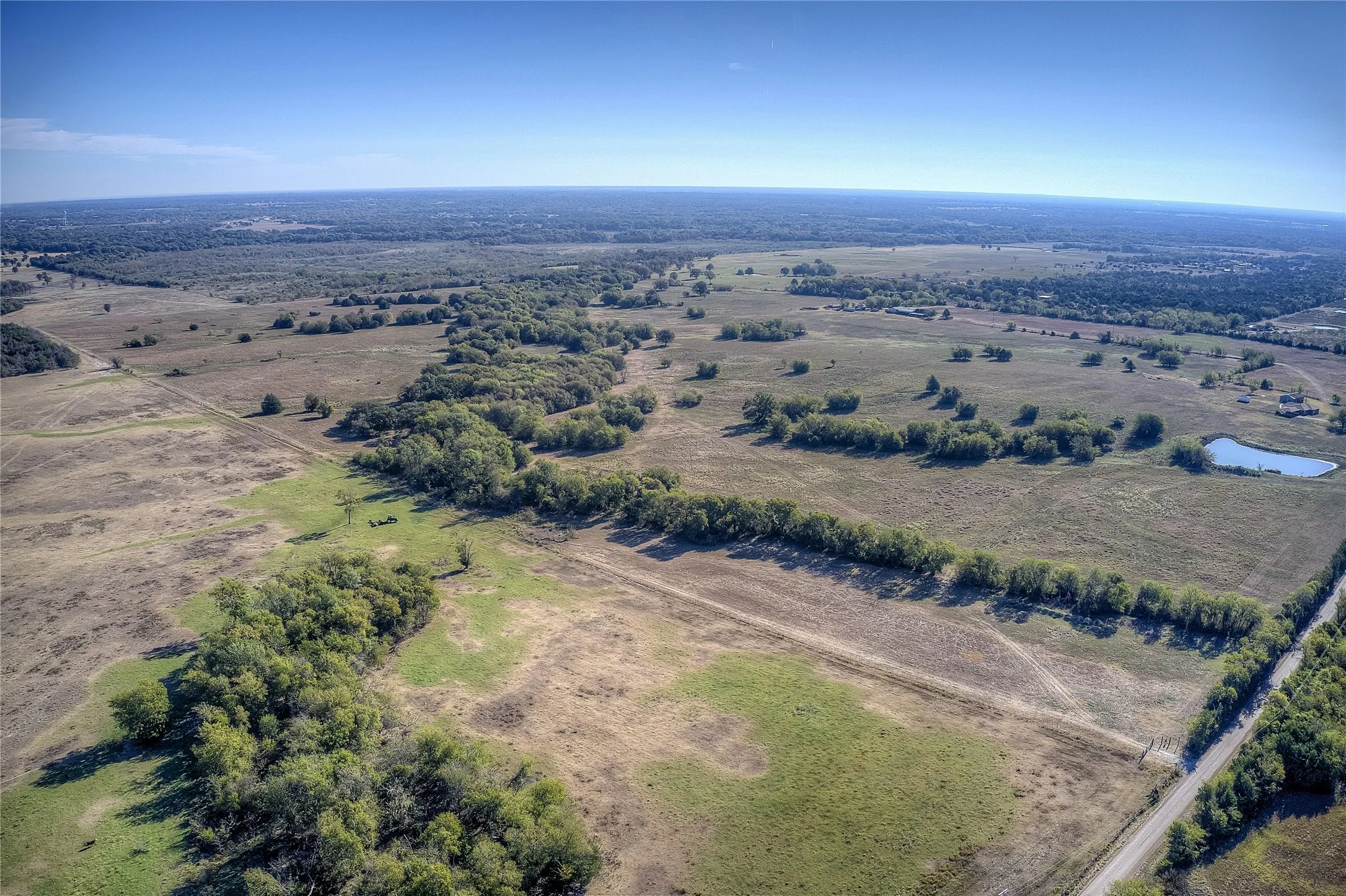 Aerial view featuring a water view and a rural view