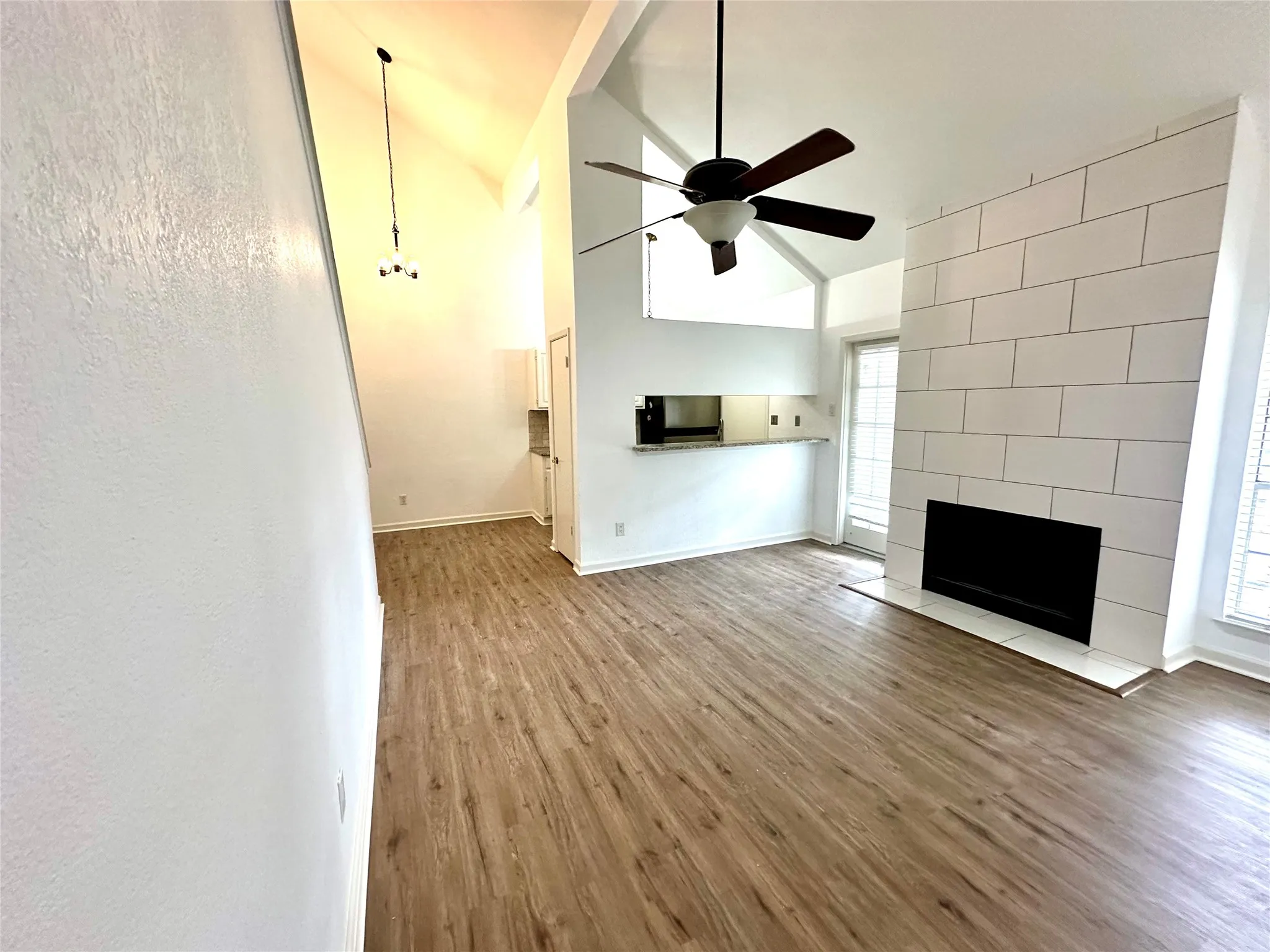 Living room featuring a wealth of natural light, hardwood / wood-style floors, and a fireplace