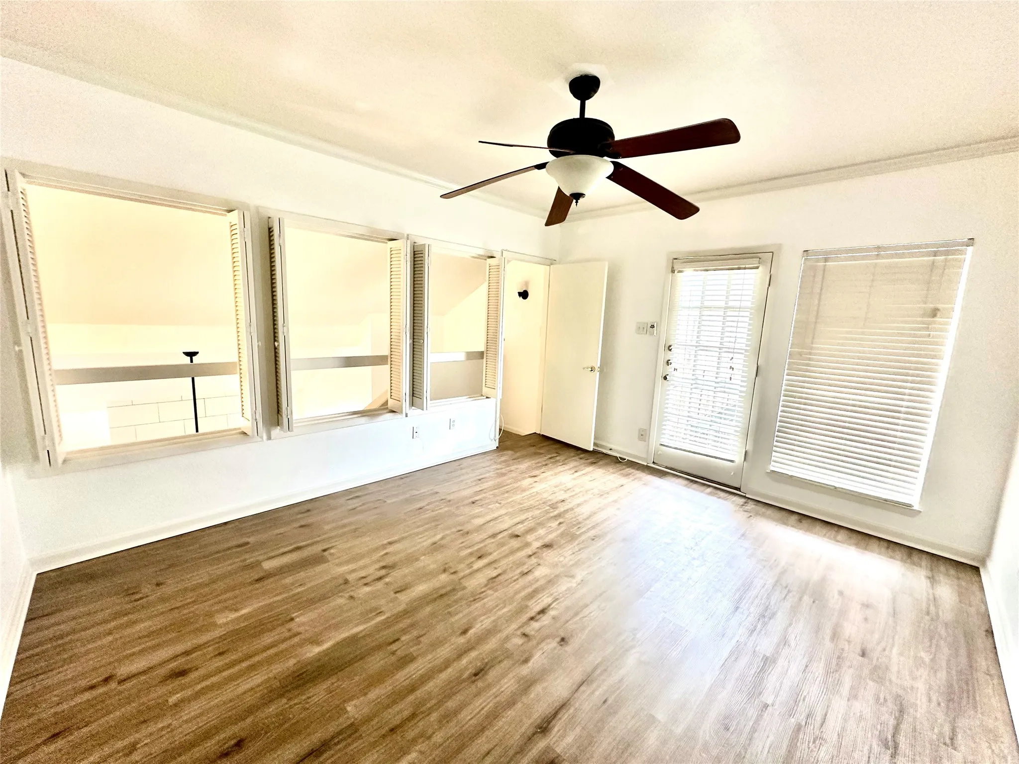 Upper bedroom featuring light hardwood / wood-style floors and ceiling fan