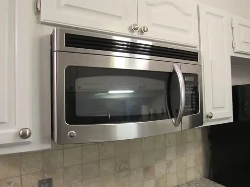 Room details featuring white cabinets and tasteful backsplash