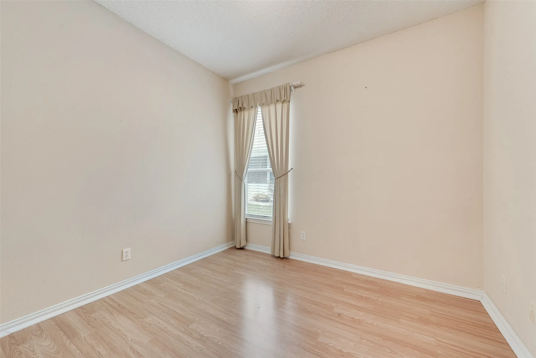 Hardwood-finish flooring complementing light-toned walls