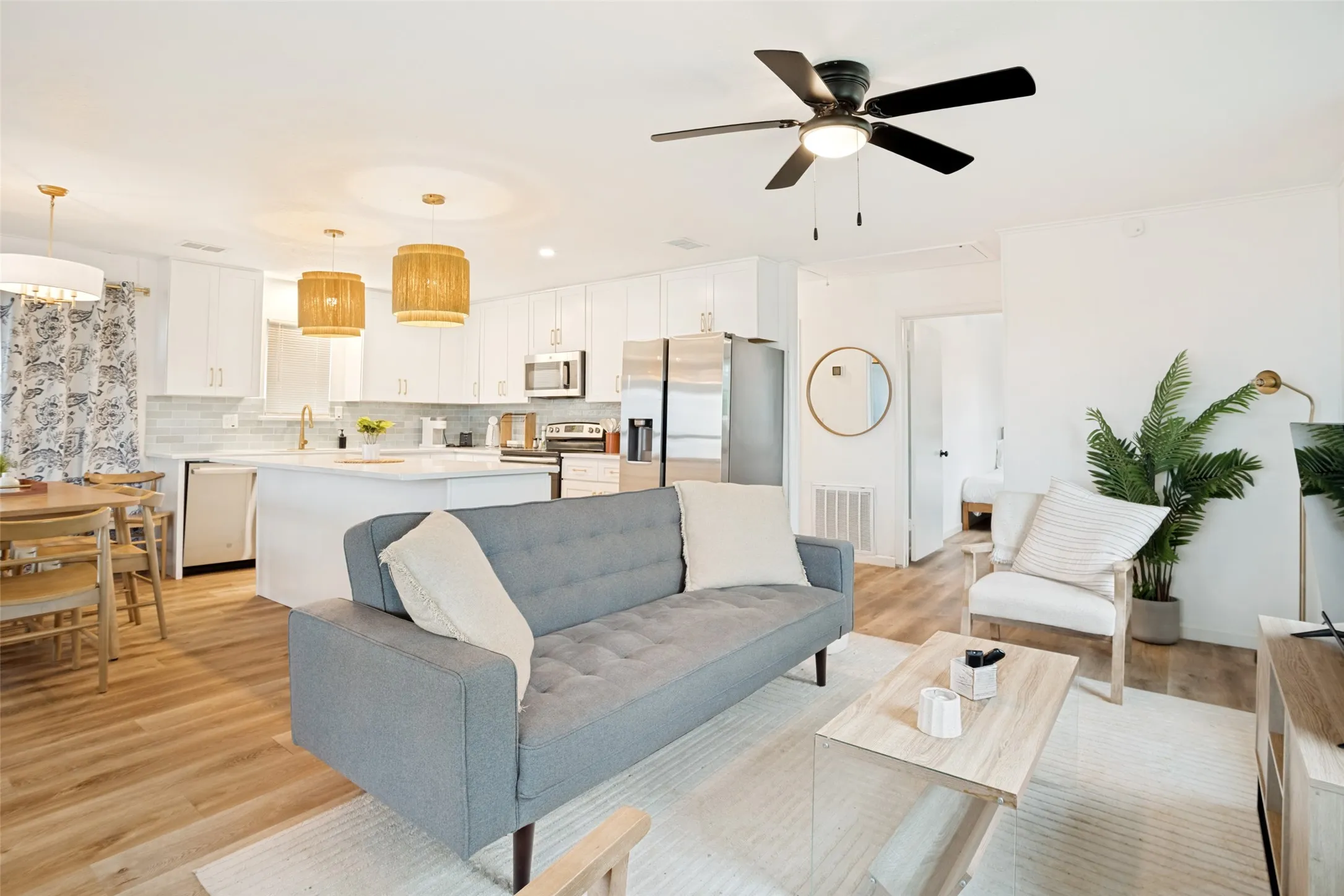 Open-concept living area featuring wood-finish flooring