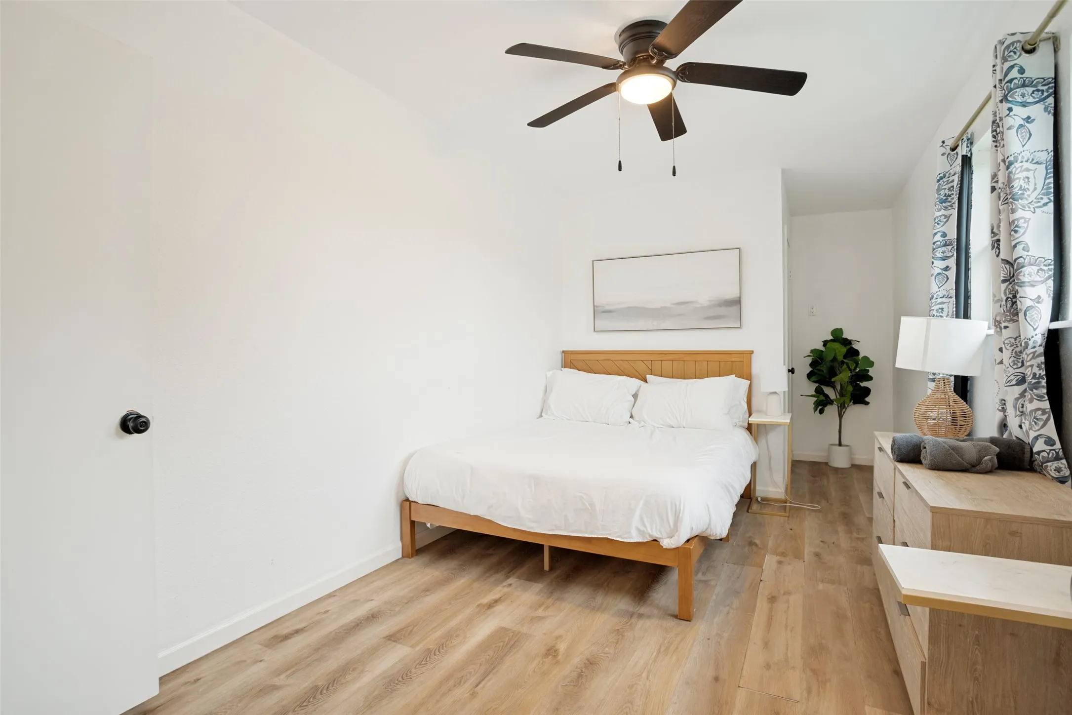 Light wood-finish flooring complements the neutral wall tones