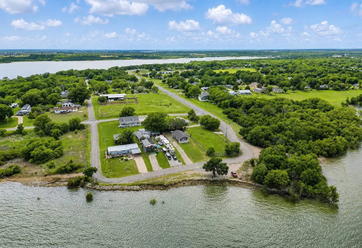 Expansive water frontage with surrounding green spaces