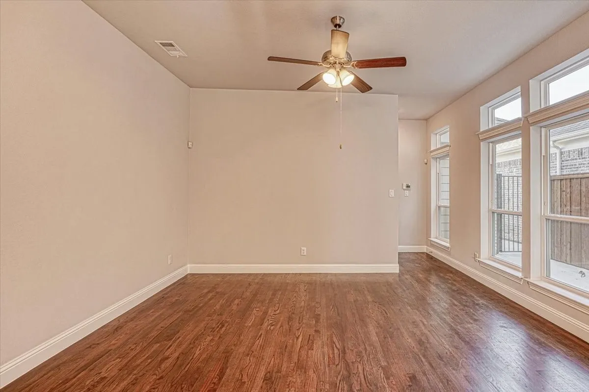 Spare room featuring ceiling fan and hardwood / wood-style flooring