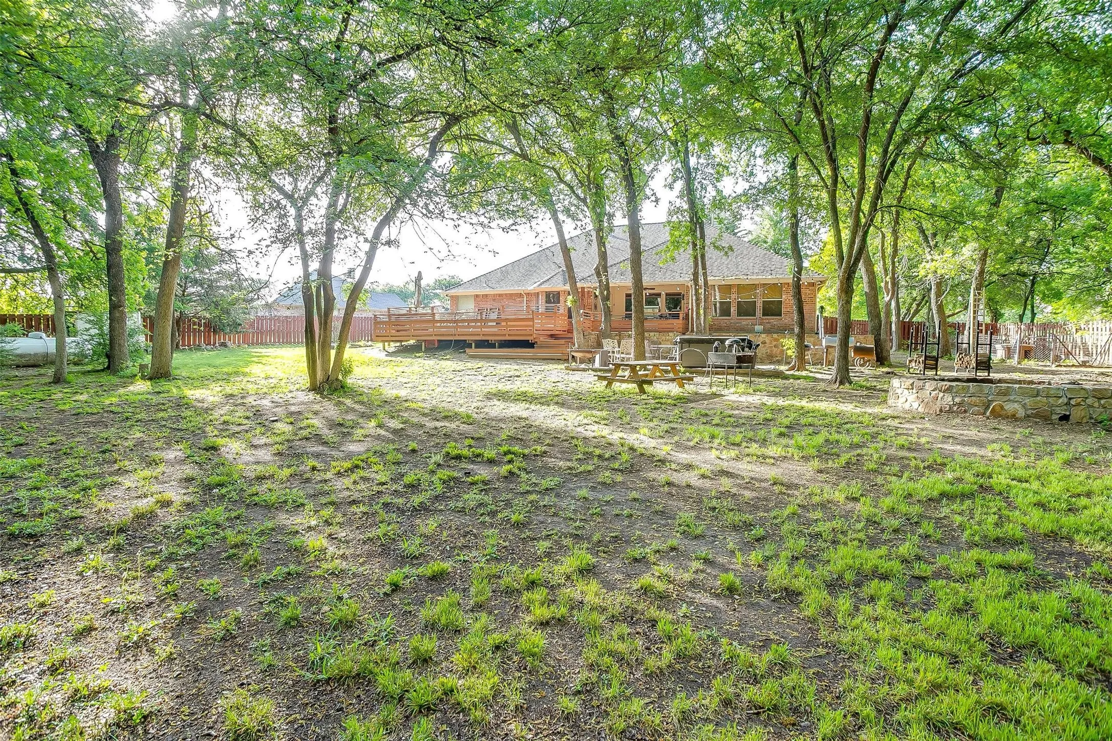 View of yard featuring a wooden deck and fence
