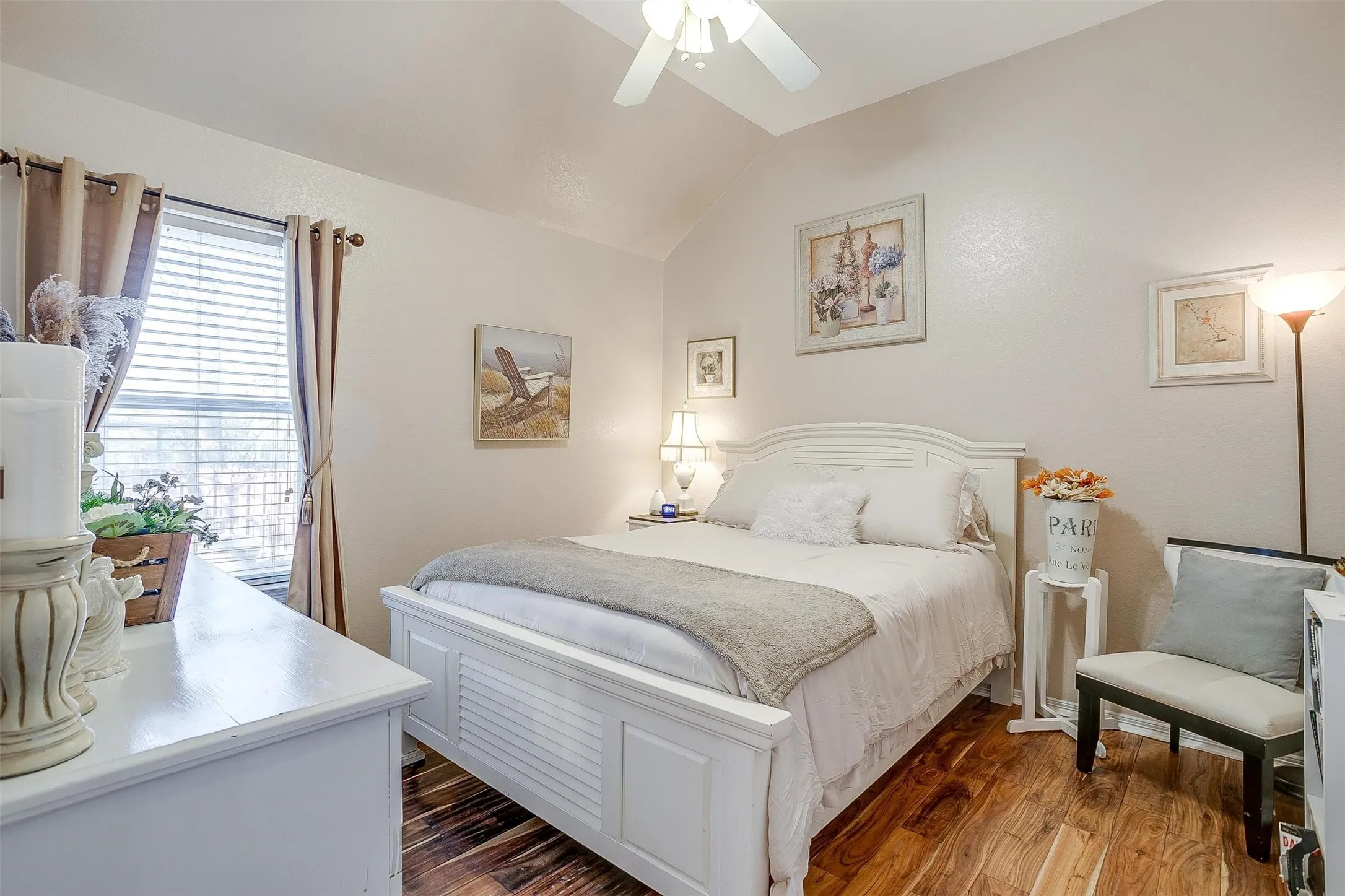 Bedroom with ceiling fan, lofted ceiling, and dark wood-style floors